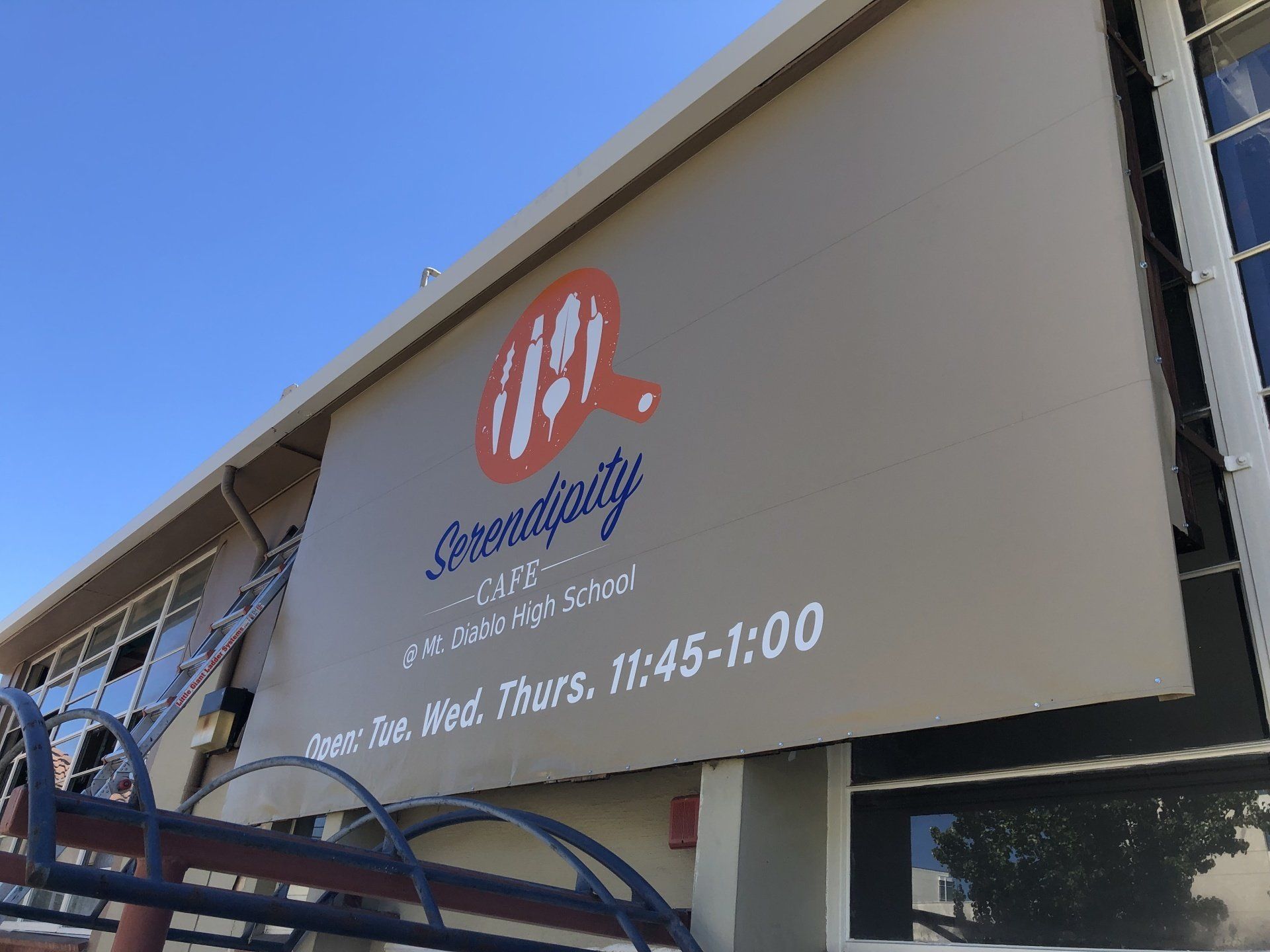 A large sign on the side of a building that says hospitality