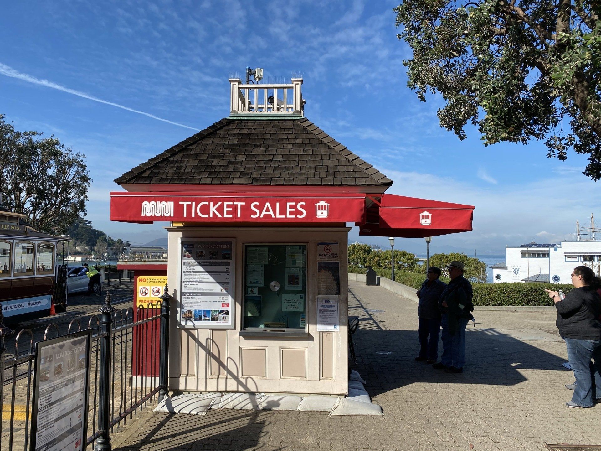 A small ticket sales booth with a red awning