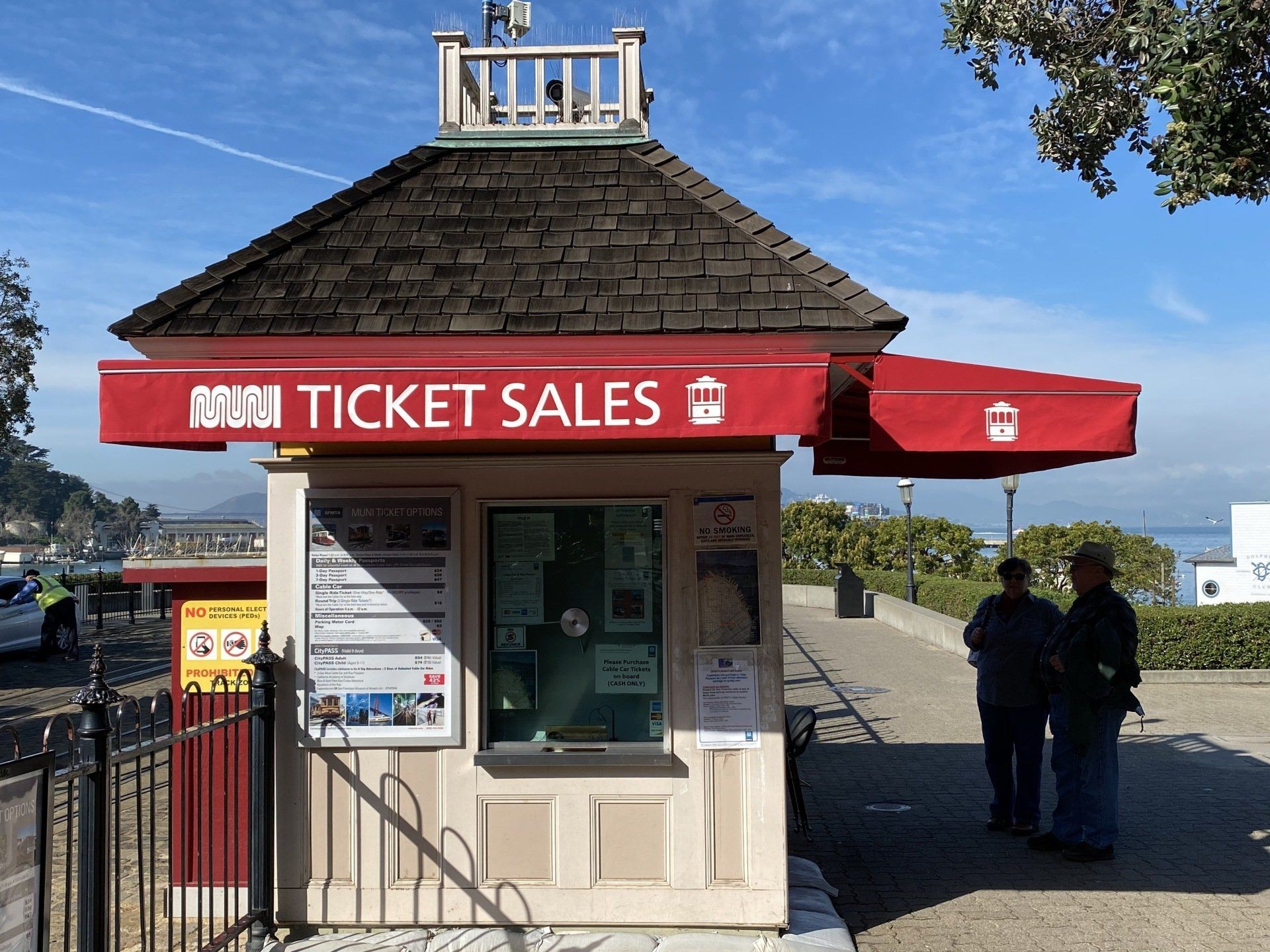 A small ticket sales booth with a red awning