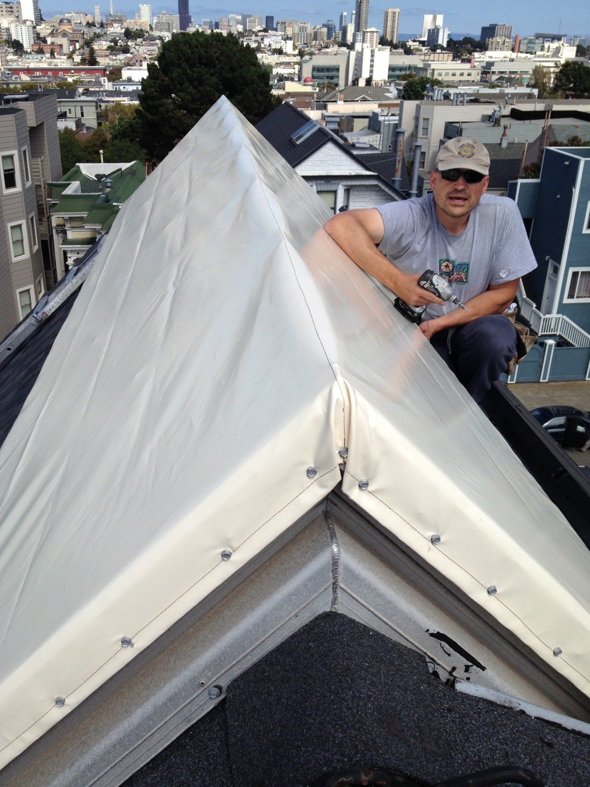 A man is working on the roof of a building
