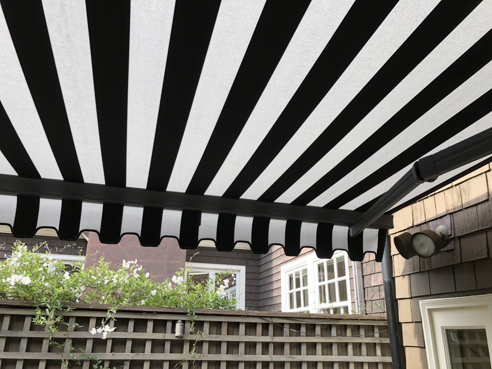 A black and white striped awning is hanging from the ceiling of a house.