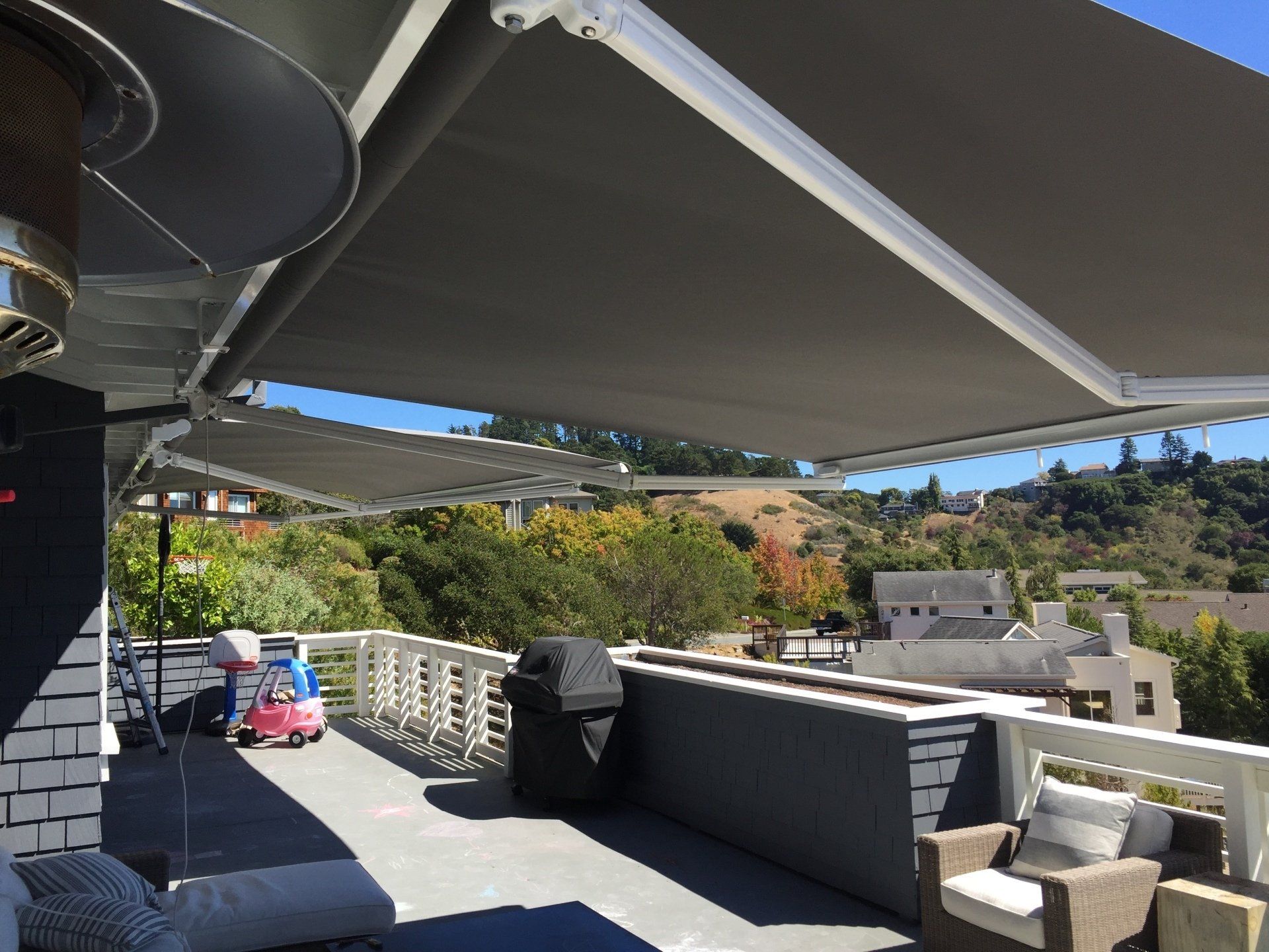 A rooftop deck with a large awning over it