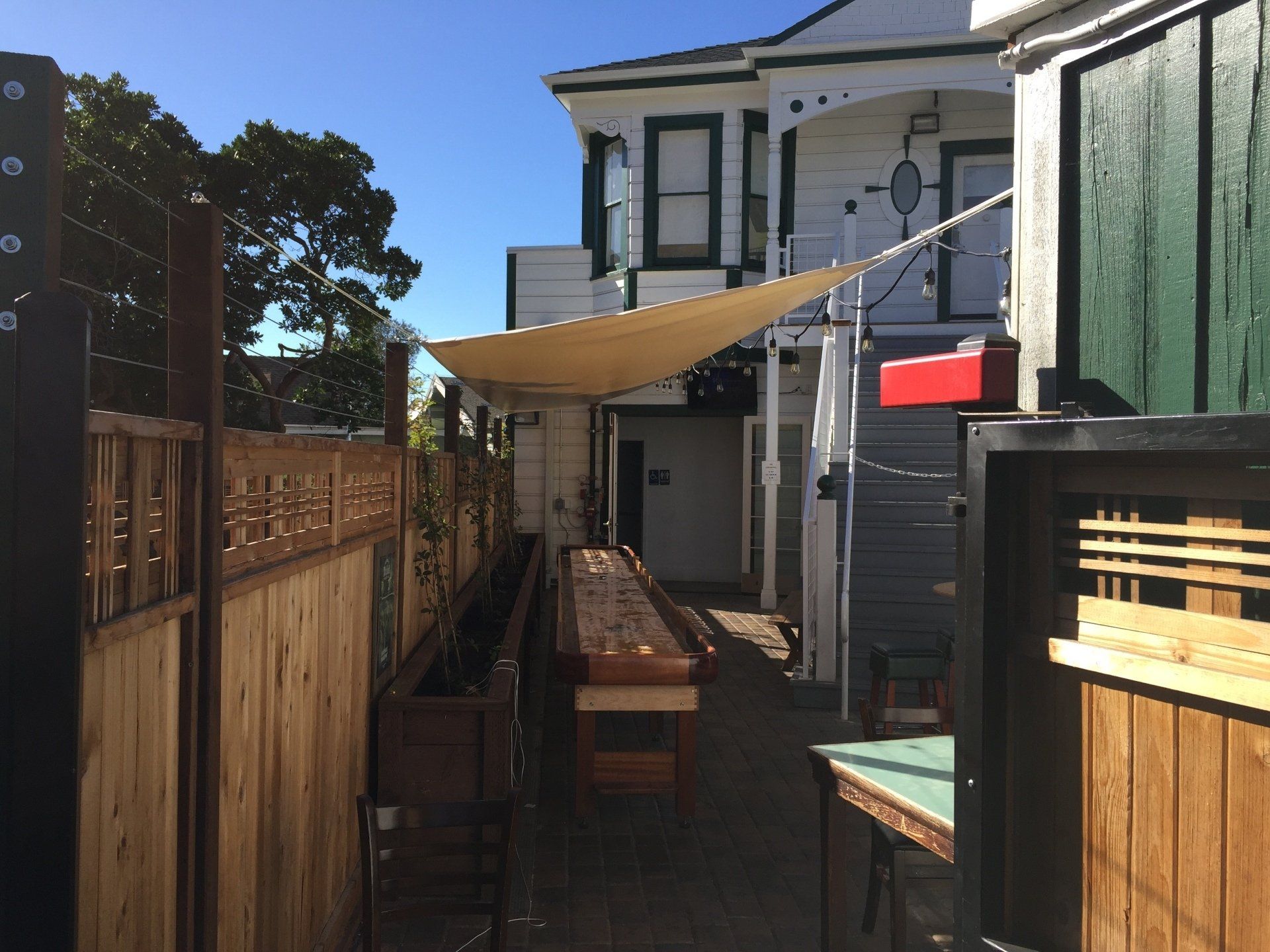 A house with a fence and a table in front of it