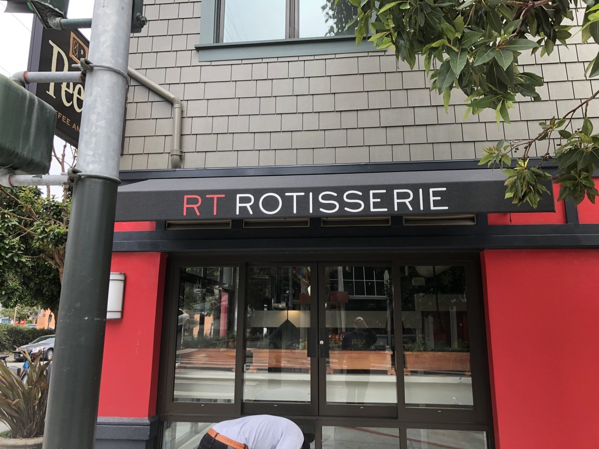 A red and white building with a sign that says rt rotisserie