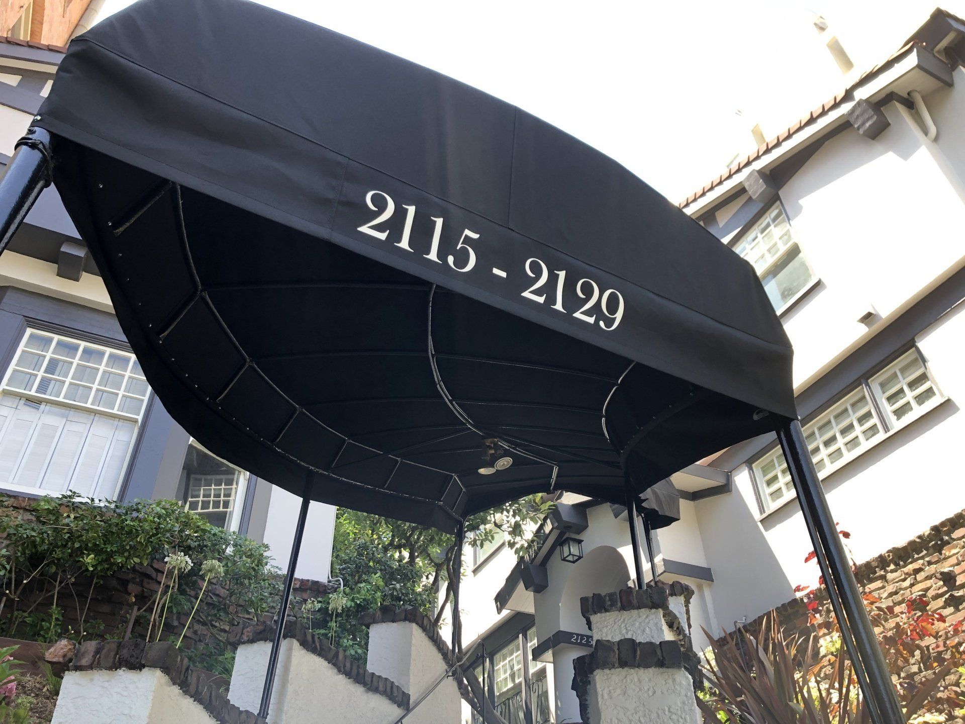 A black awning with the numbers 2115-2129 on it