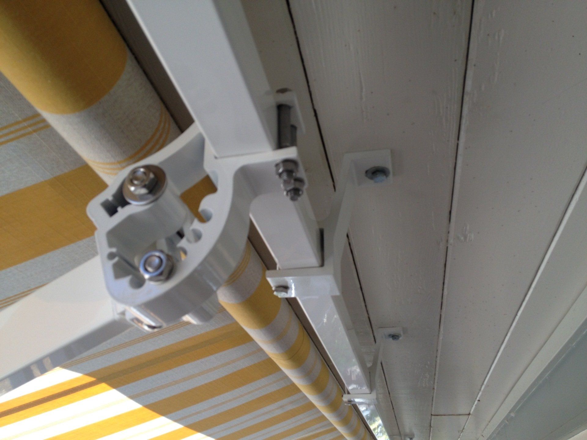 A yellow and white striped awning is hanging from the ceiling