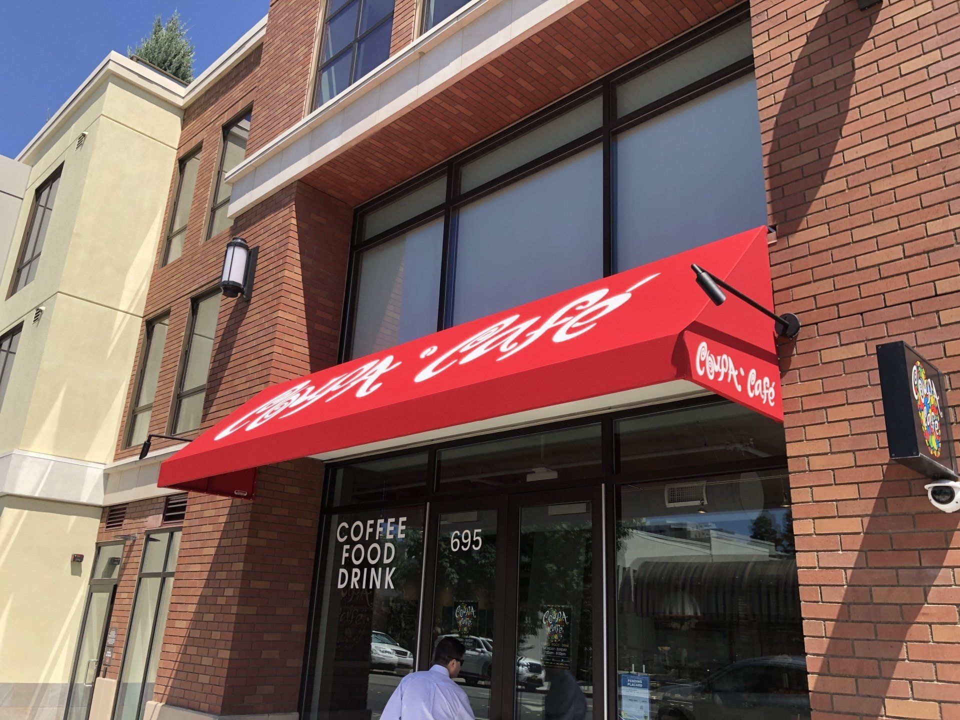 A red awning over the entrance of a coffee shop