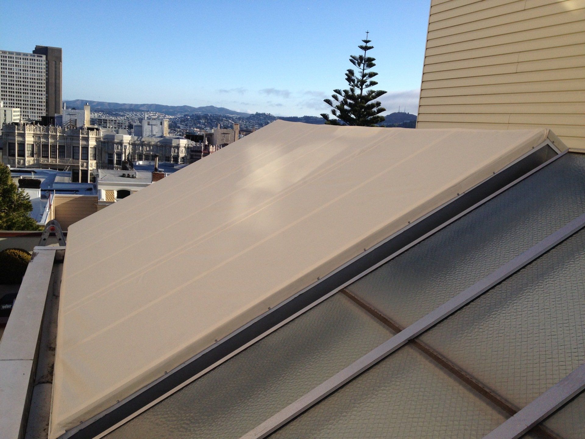 A roof with a view of a city in the background