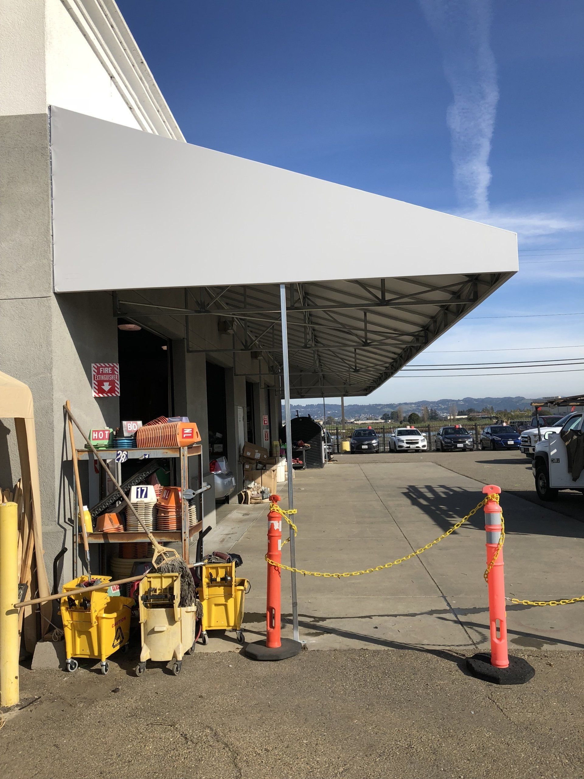 A store front with a white awning over it