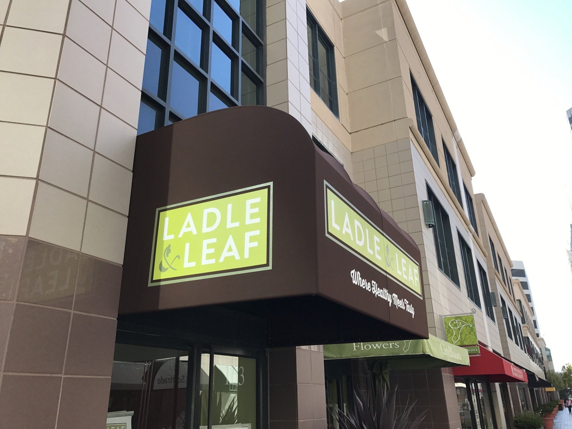 A building with an awning that says ladle & leaf