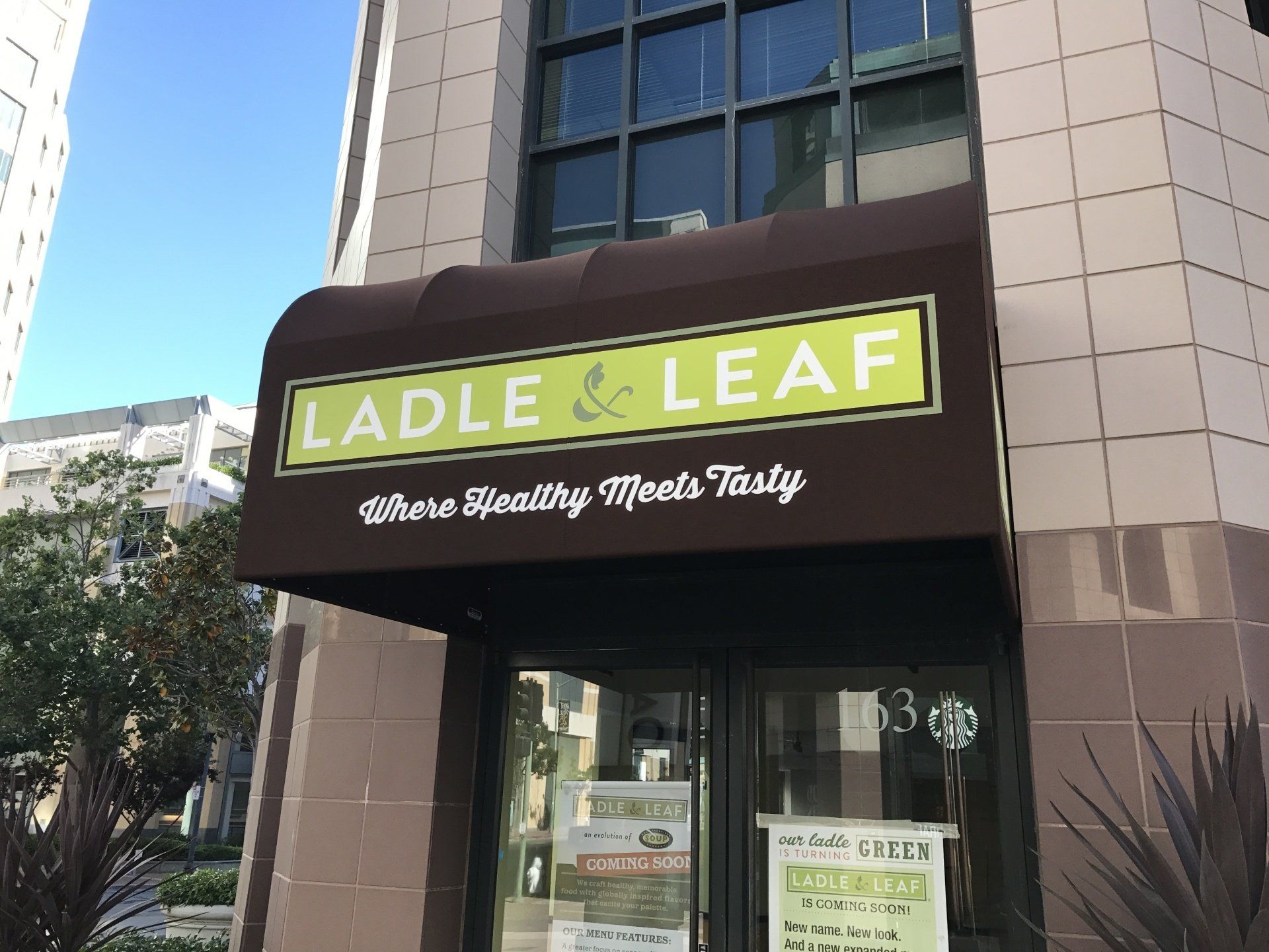 A restaurant called ladle & leaf is located on the corner of a building