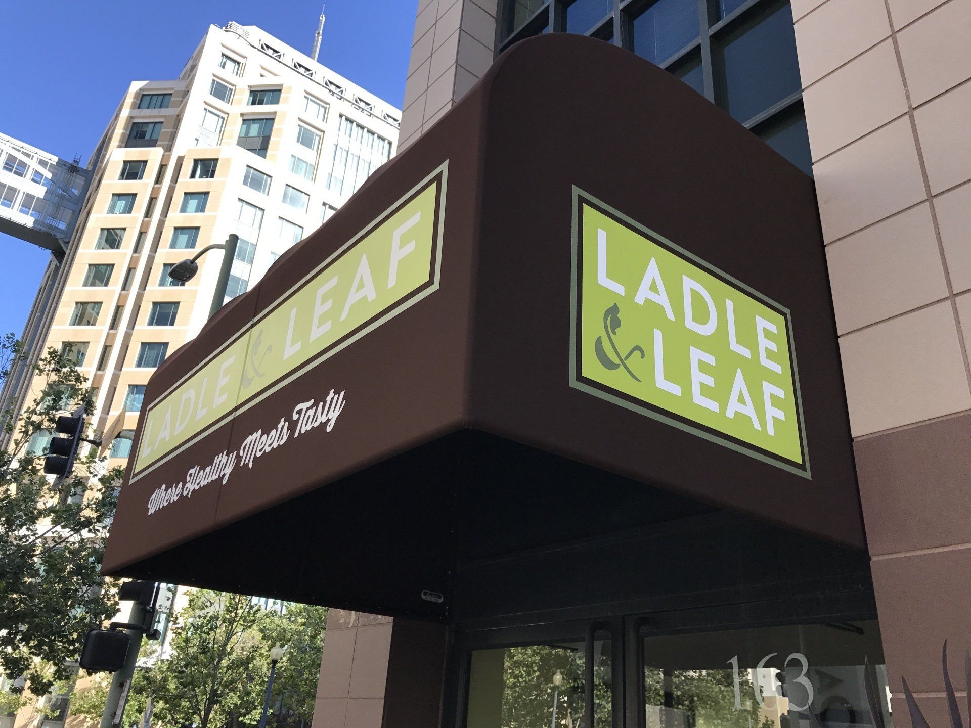A brown awning with the words ladle & leaf on it