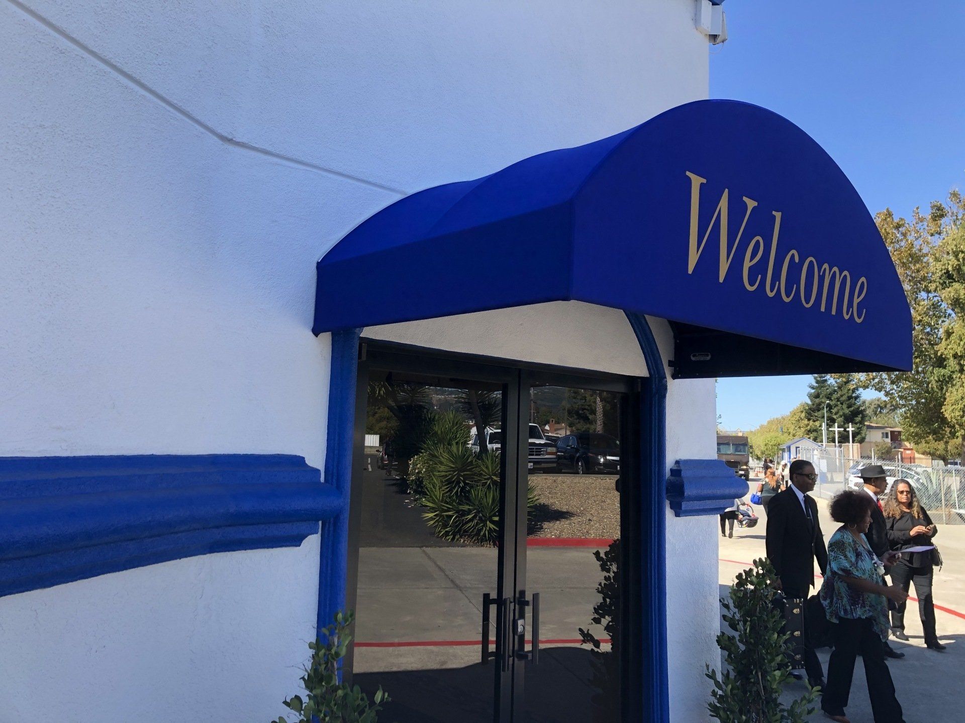 A blue awning with the word welcome on it