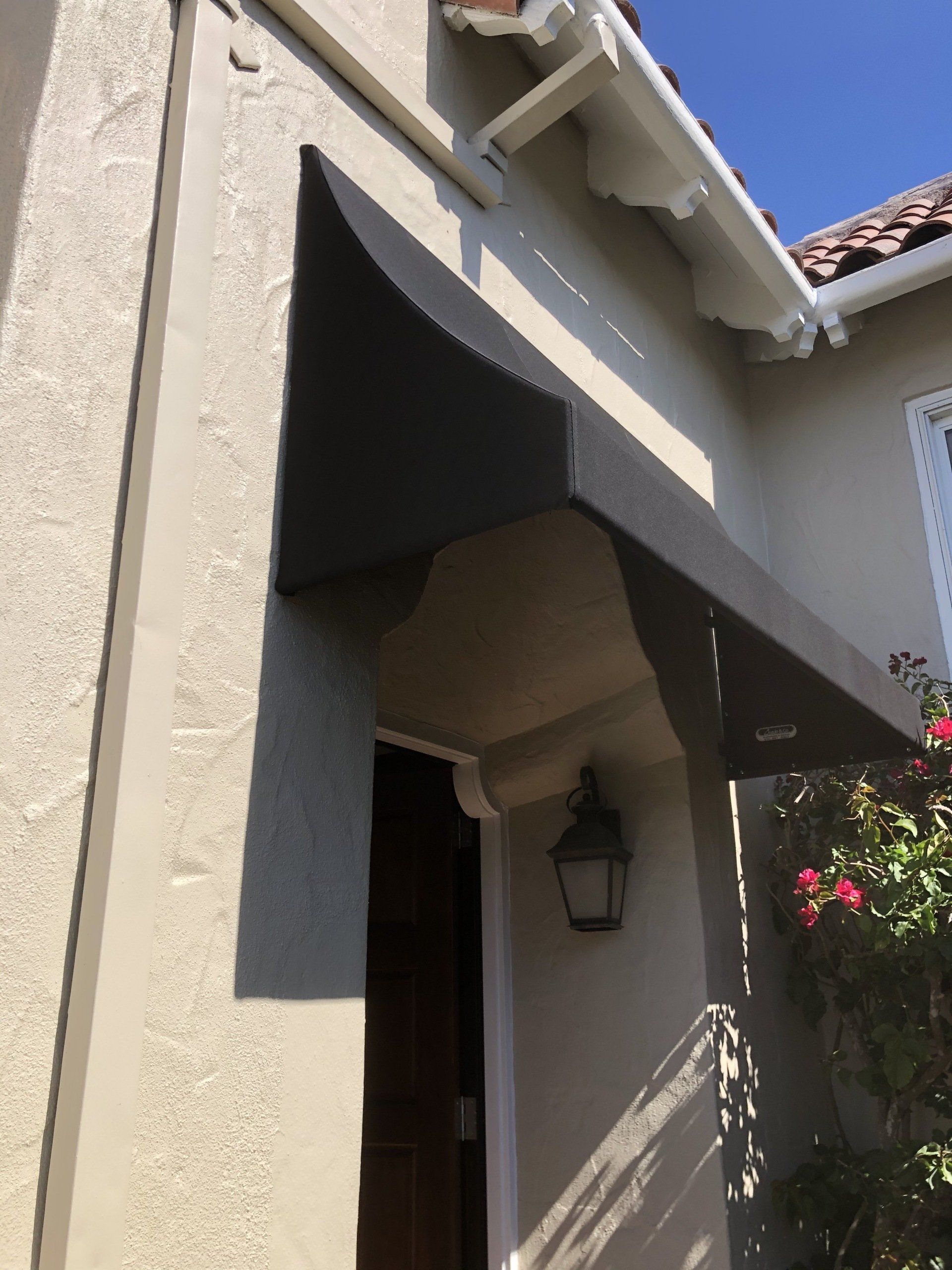 A house with a black awning over the front door