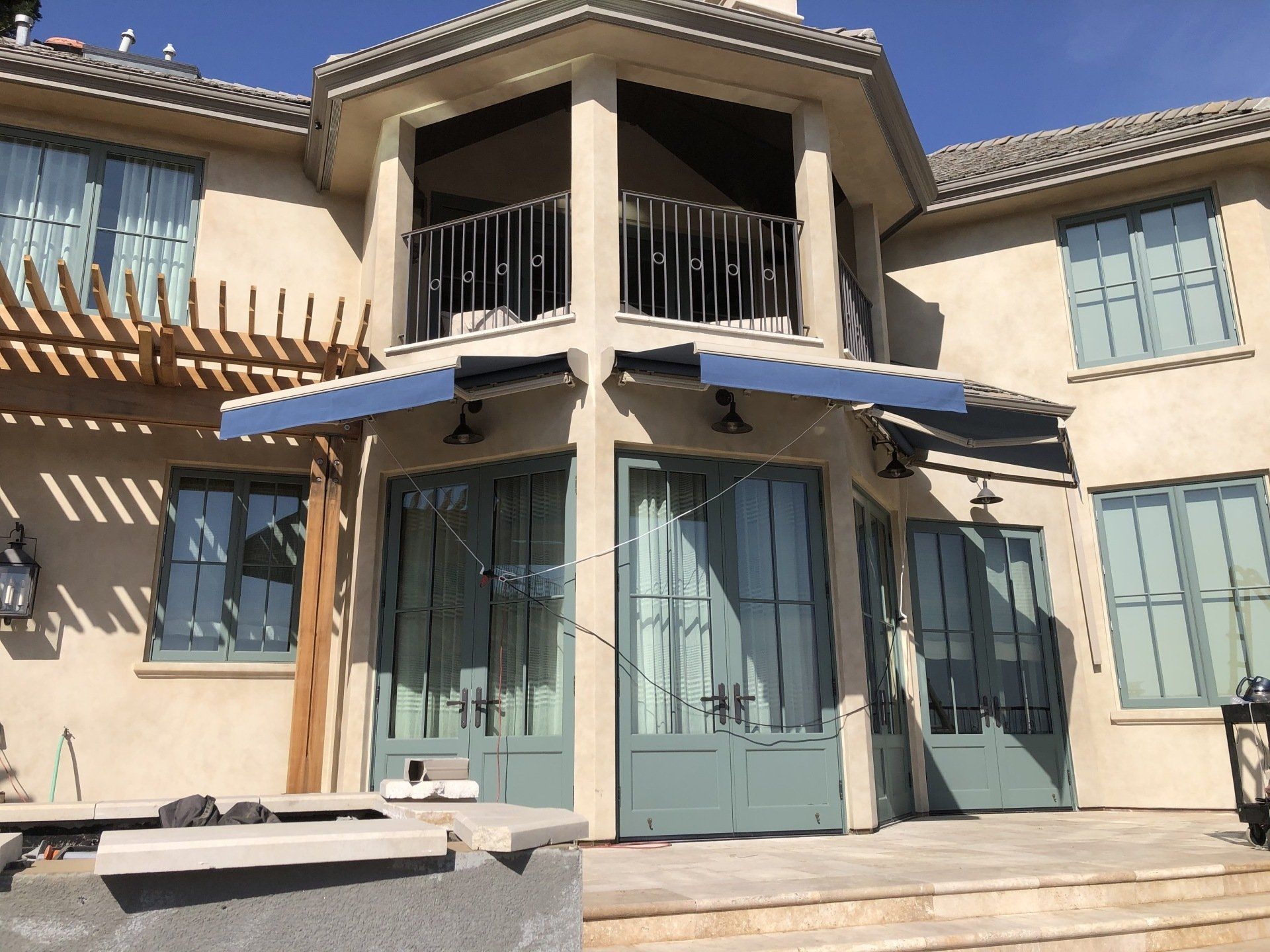 A large house with a blue awning on the front of it.