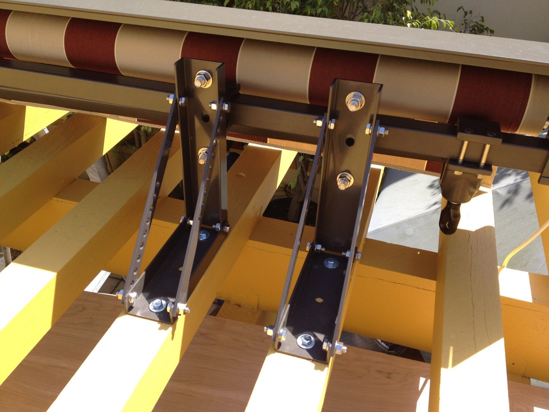 A striped awning is attached to a wooden structure