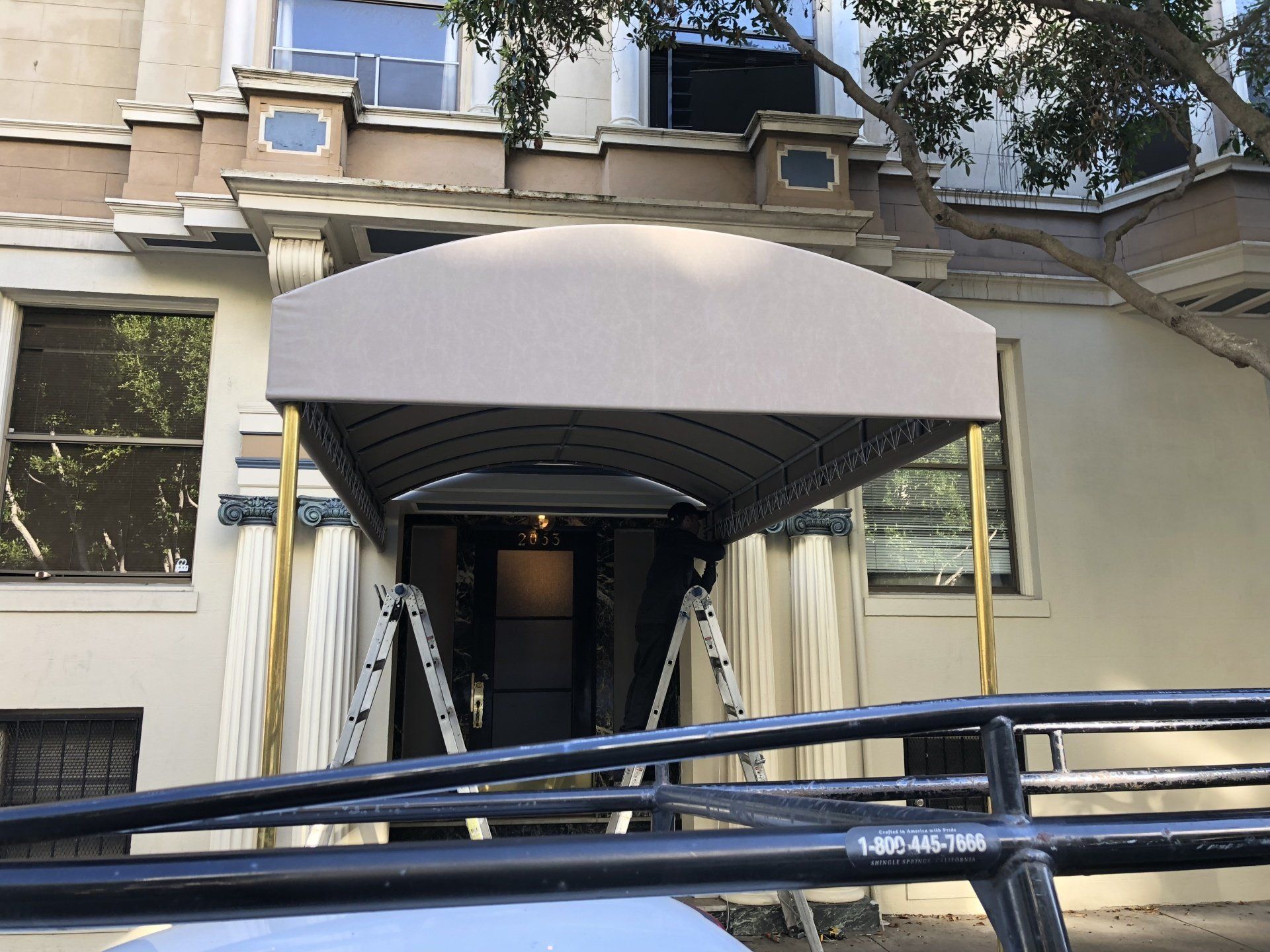 A canopy is being installed on the front of a building.