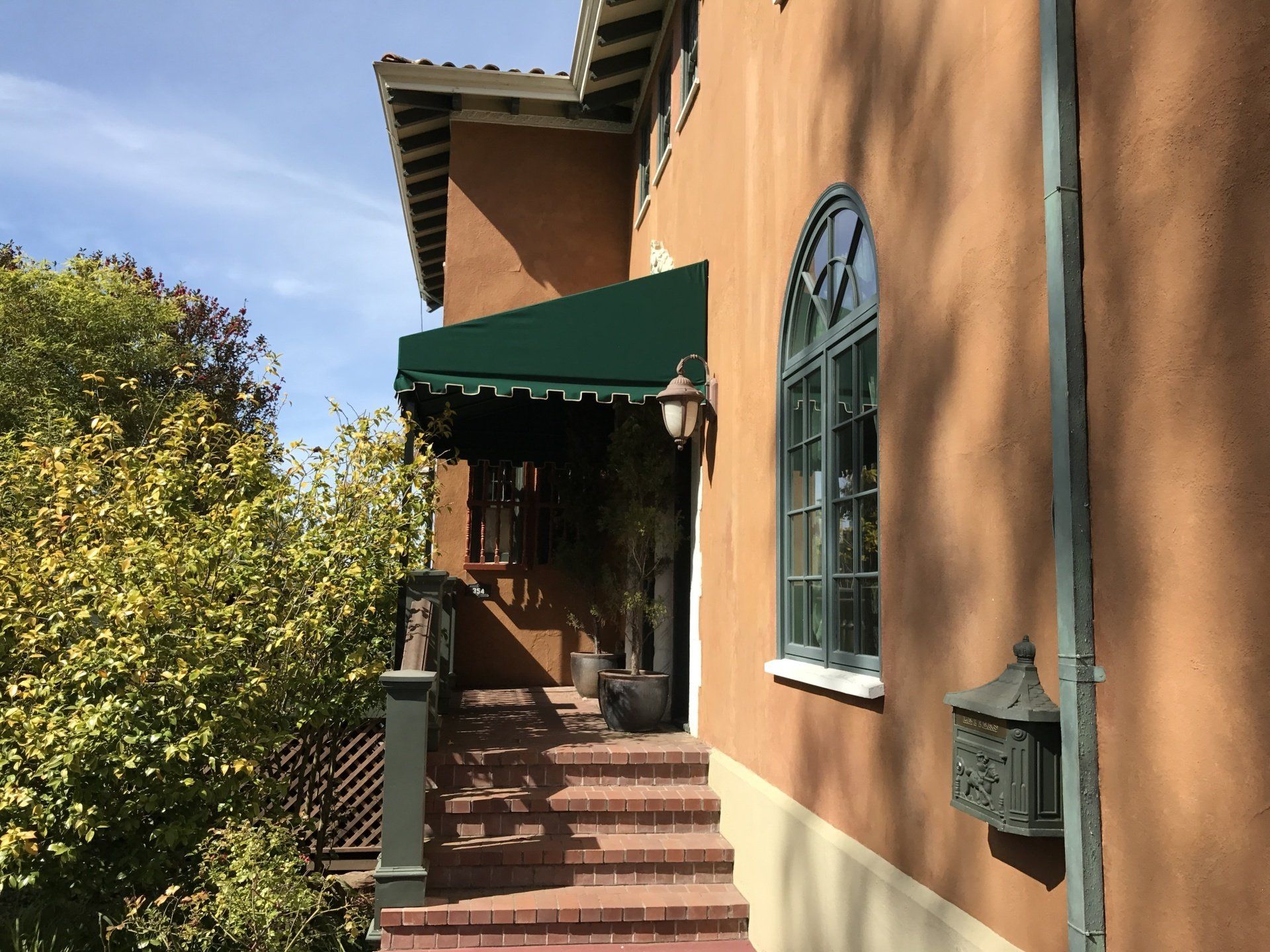 A house with a green awning over the front door
