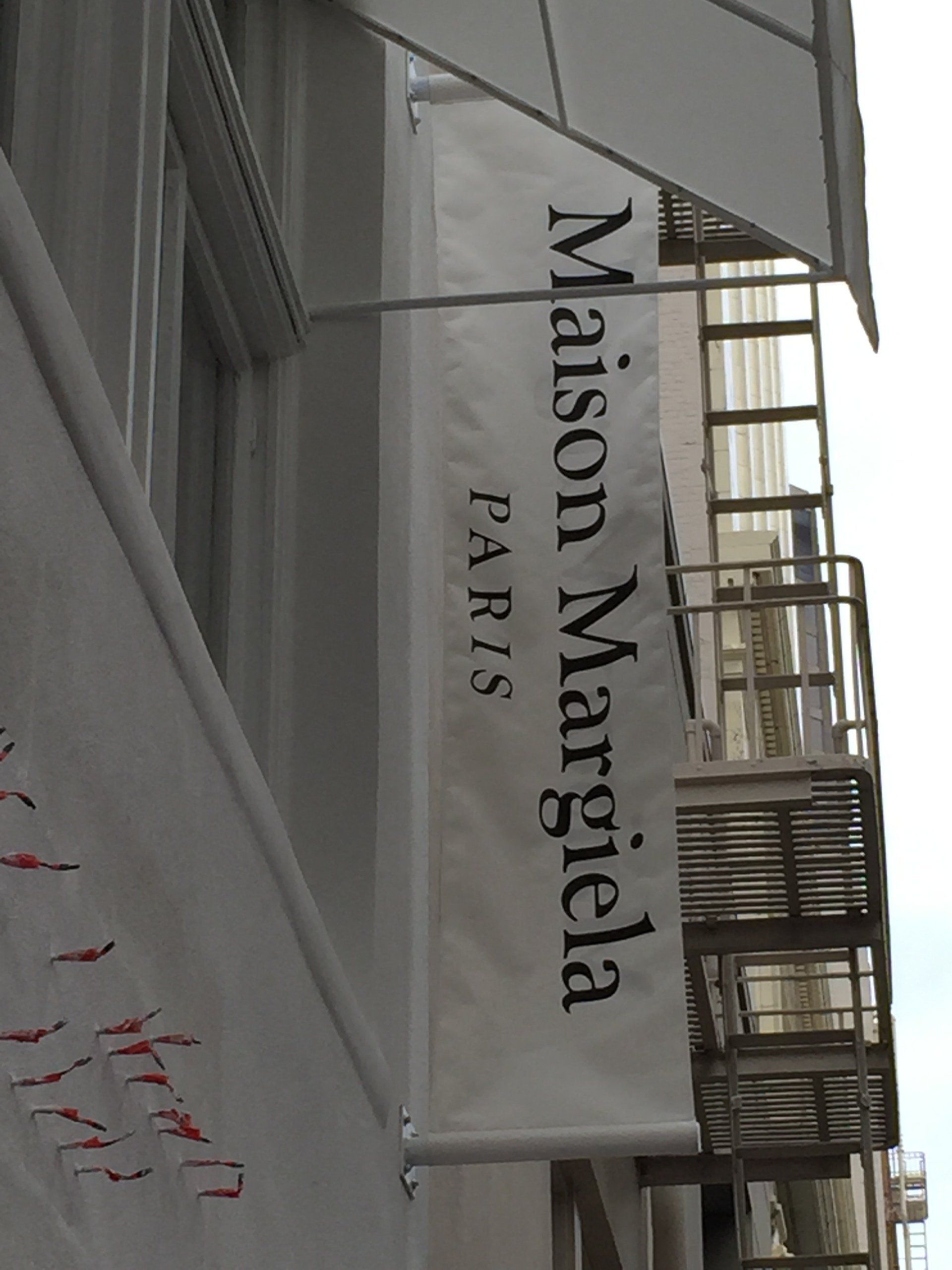 A white sign that says maison margela paris
