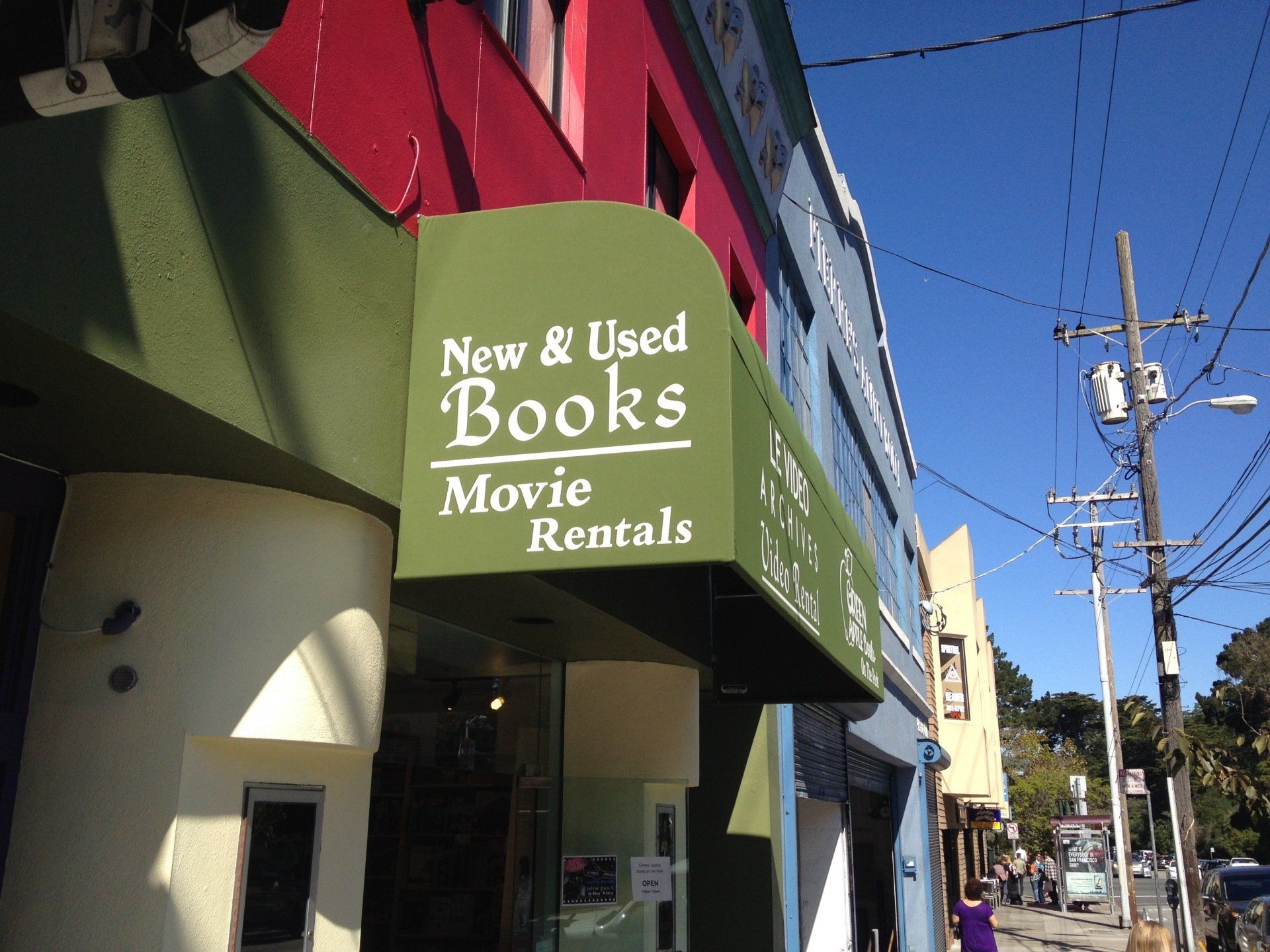 A green awning says new and used books movie rentals
