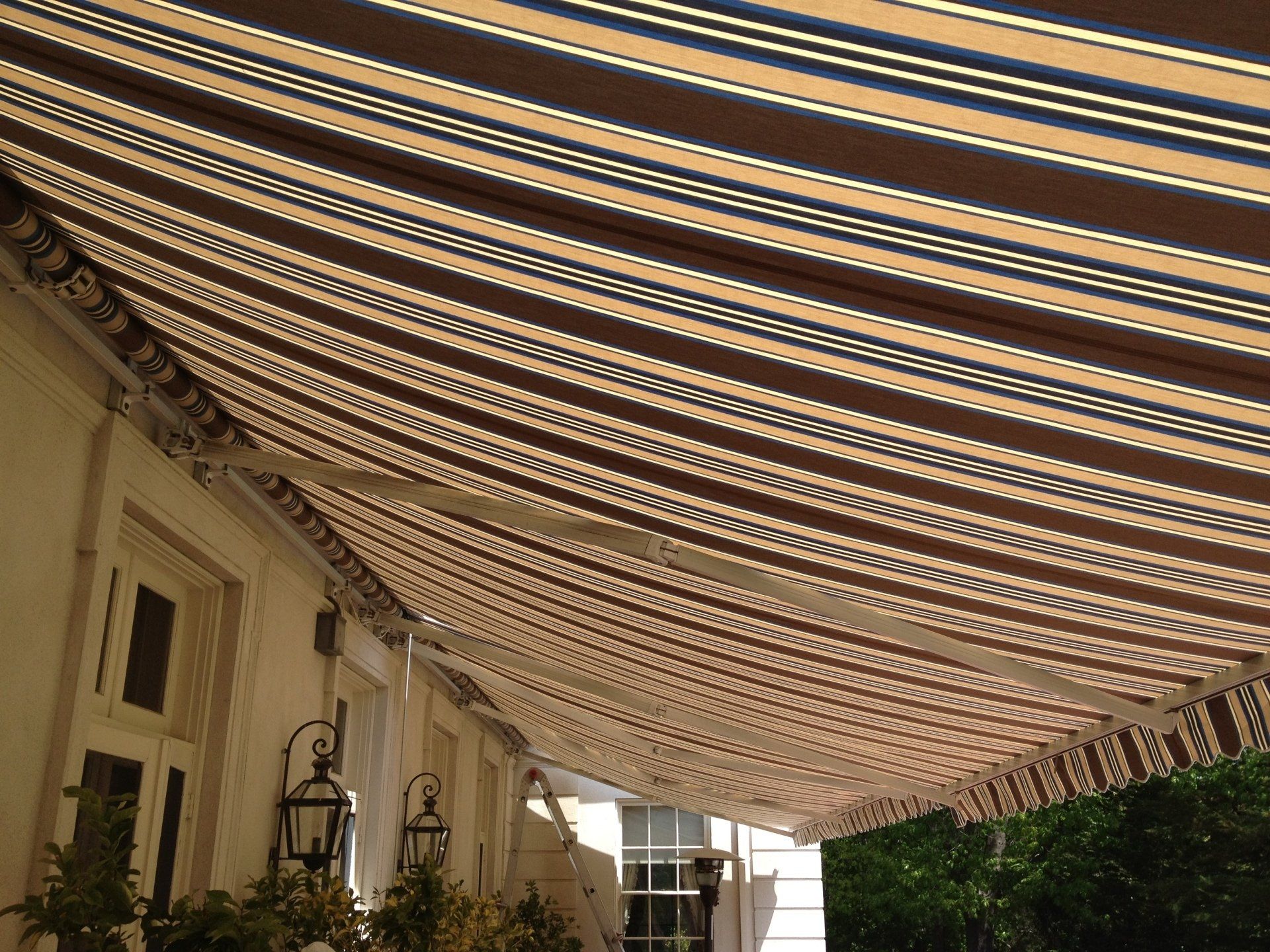 A striped awning is hanging from the side of a building