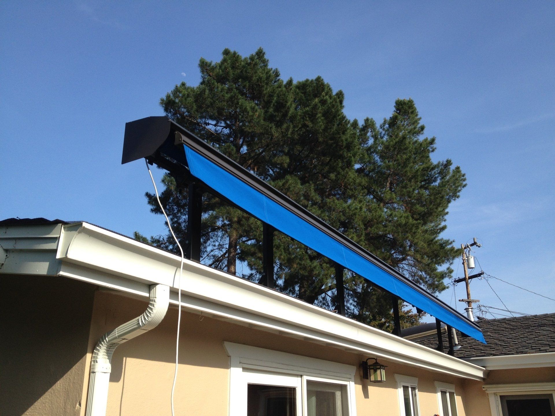 A house with a blue awning on the roof