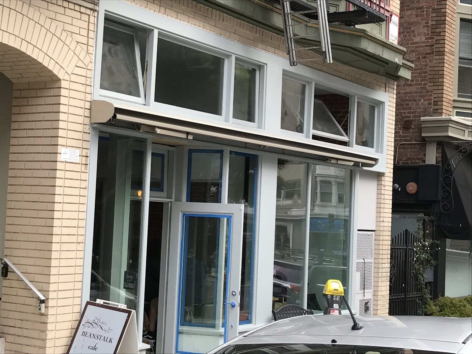 A car is parked in front of a brick building