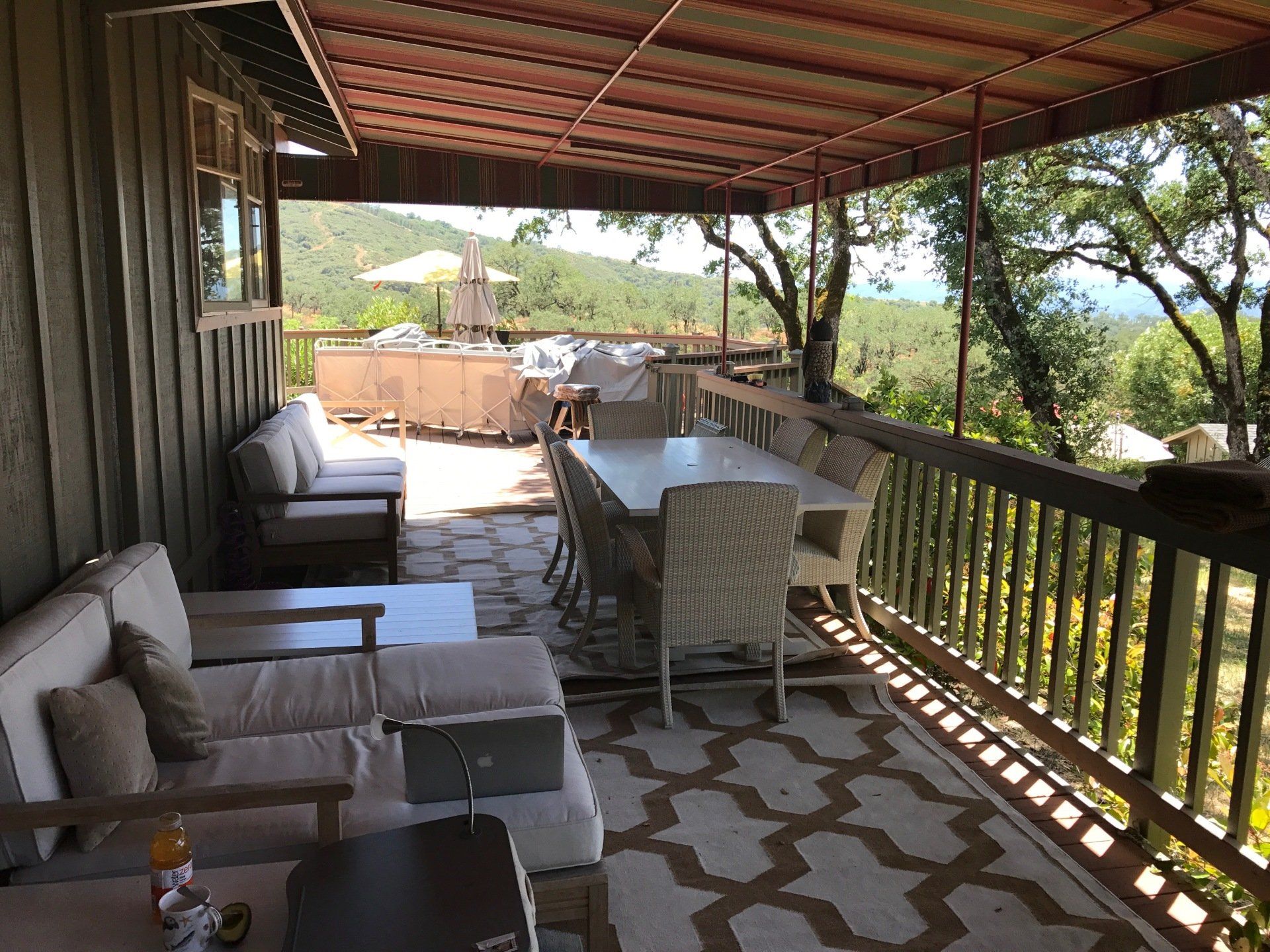 A porch with a table and chairs on it