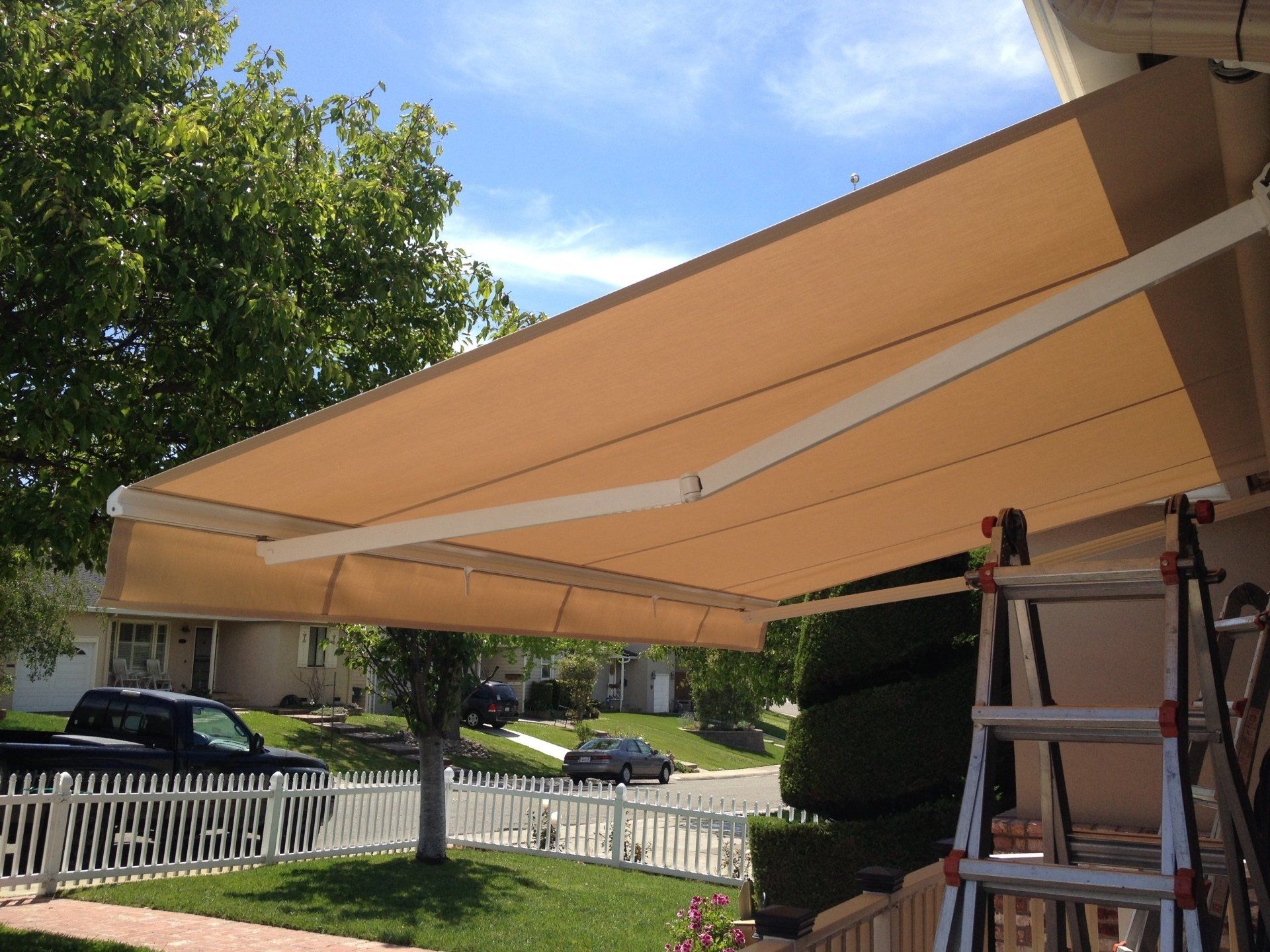 An awning is being installed on the side of a house.