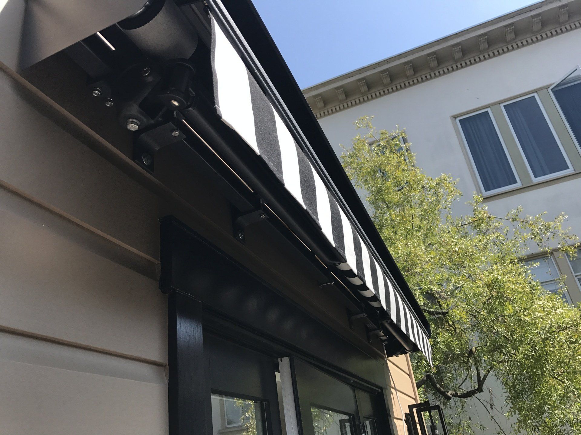 A black and white awning on the side of a building