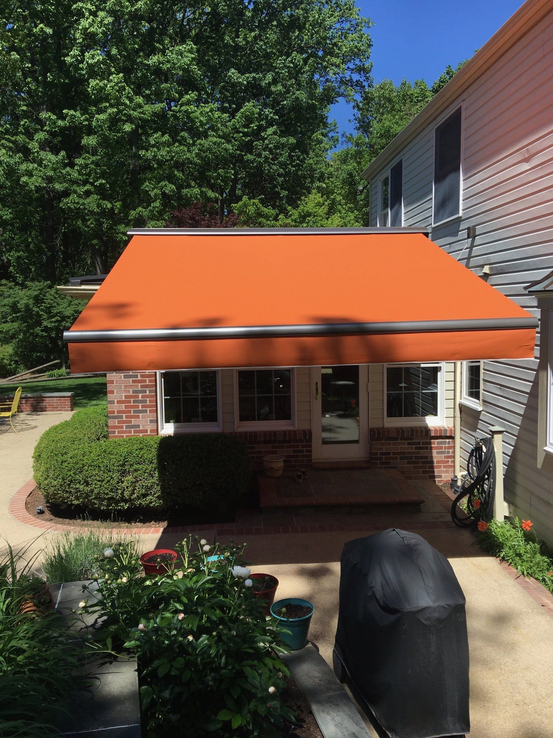A house with an orange awning on the side of it