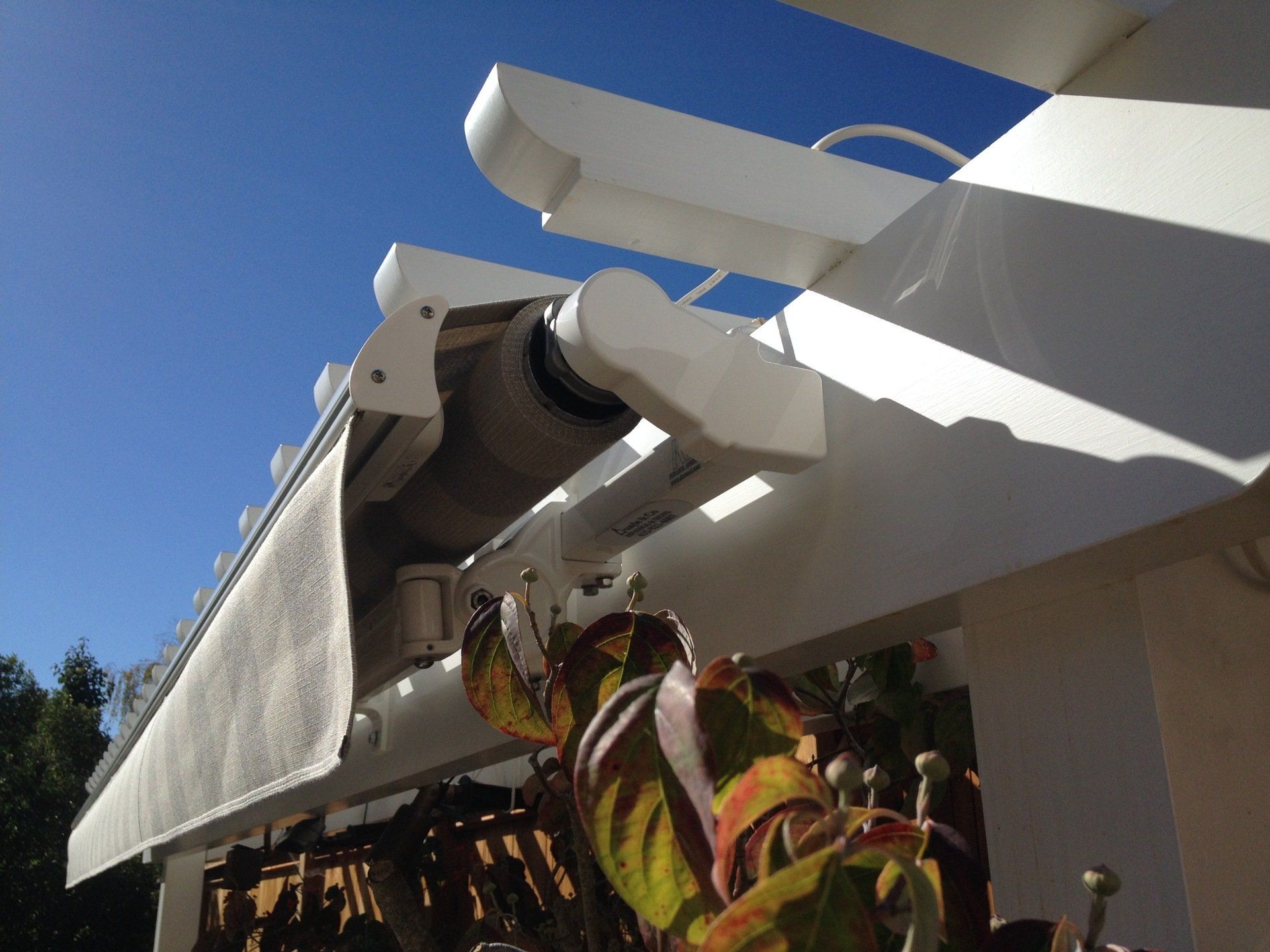 A white awning is hanging from the side of a building