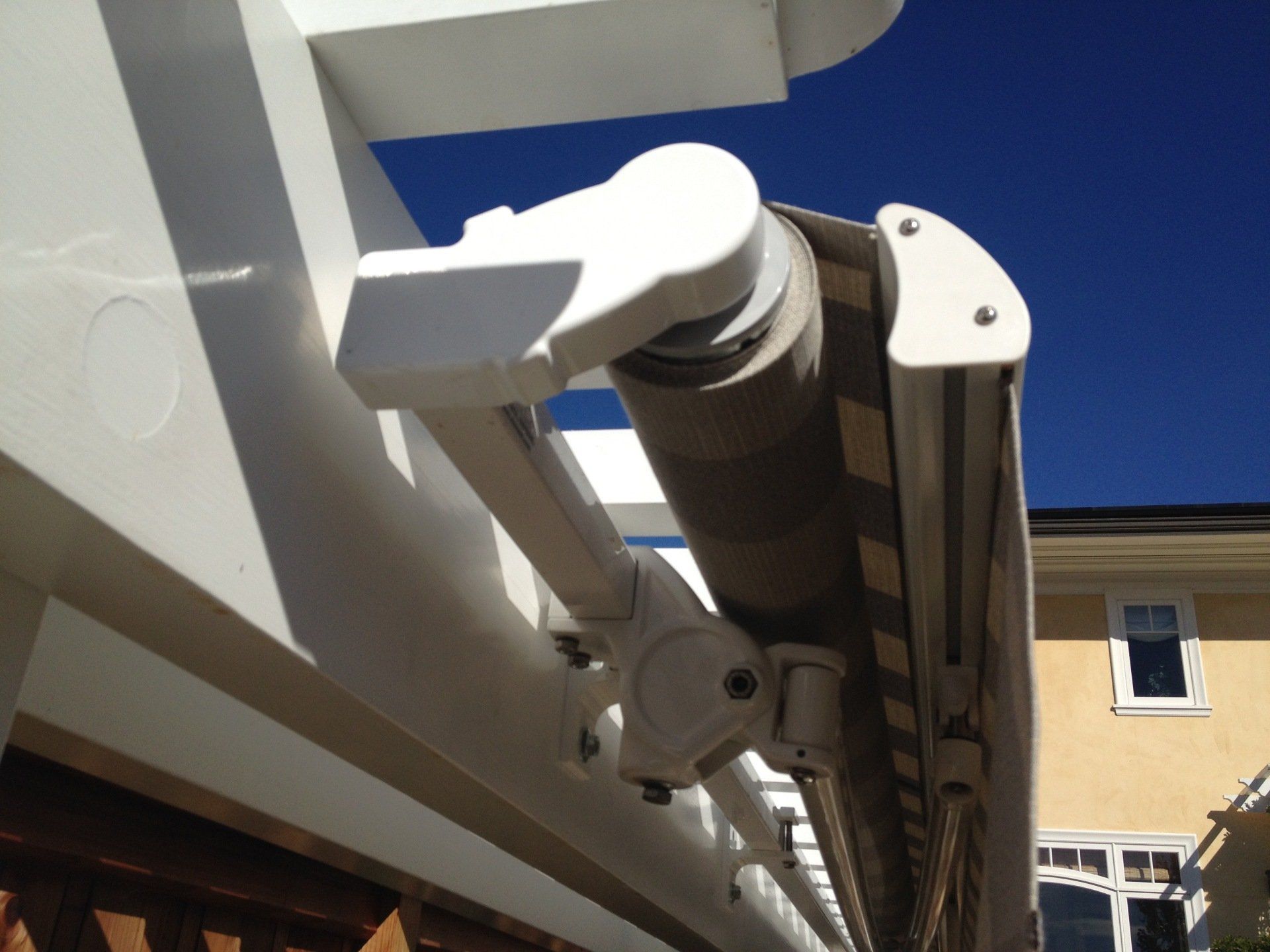 A white awning is hanging from the side of a building