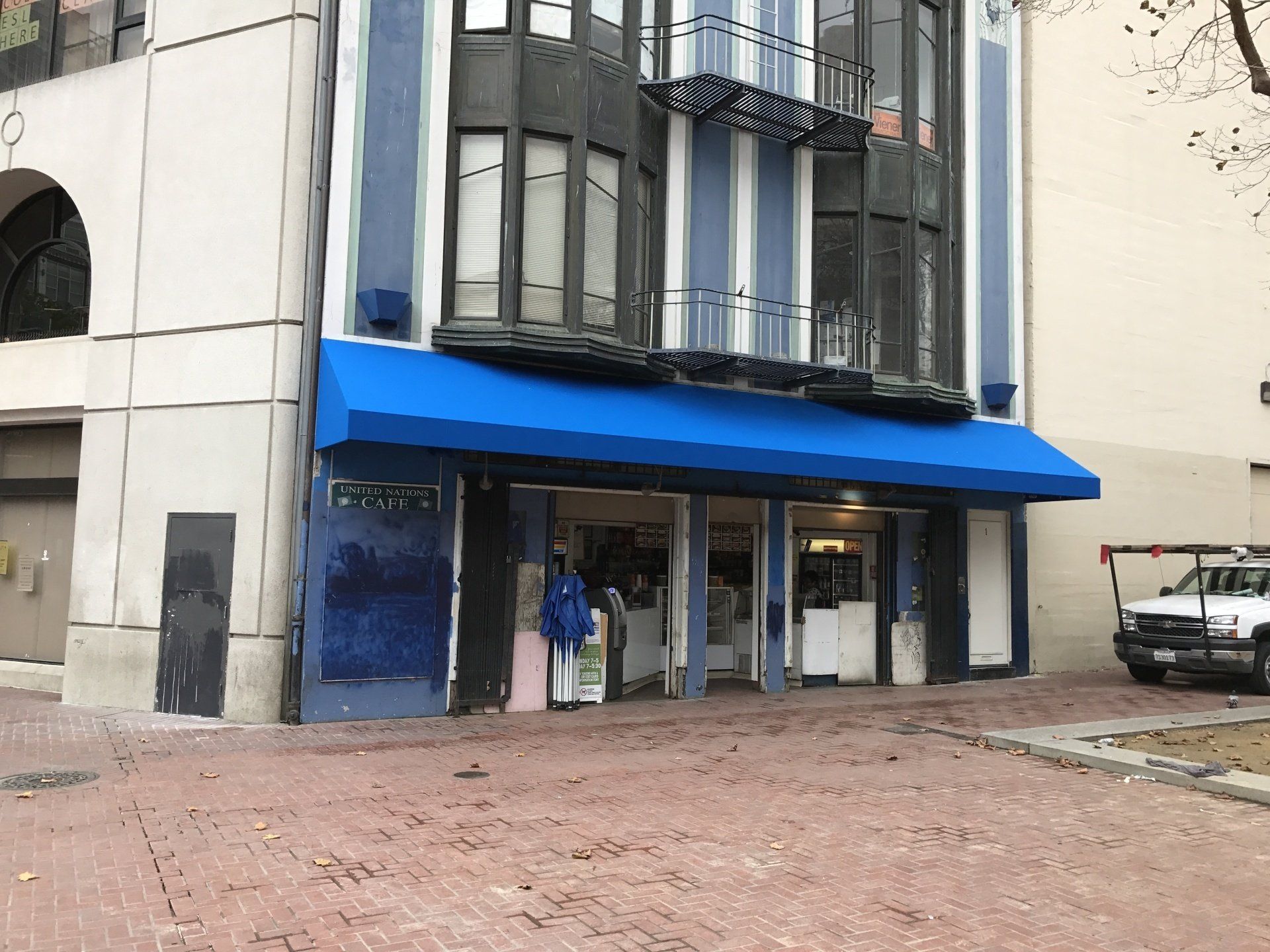 A building with a blue awning on the front of it