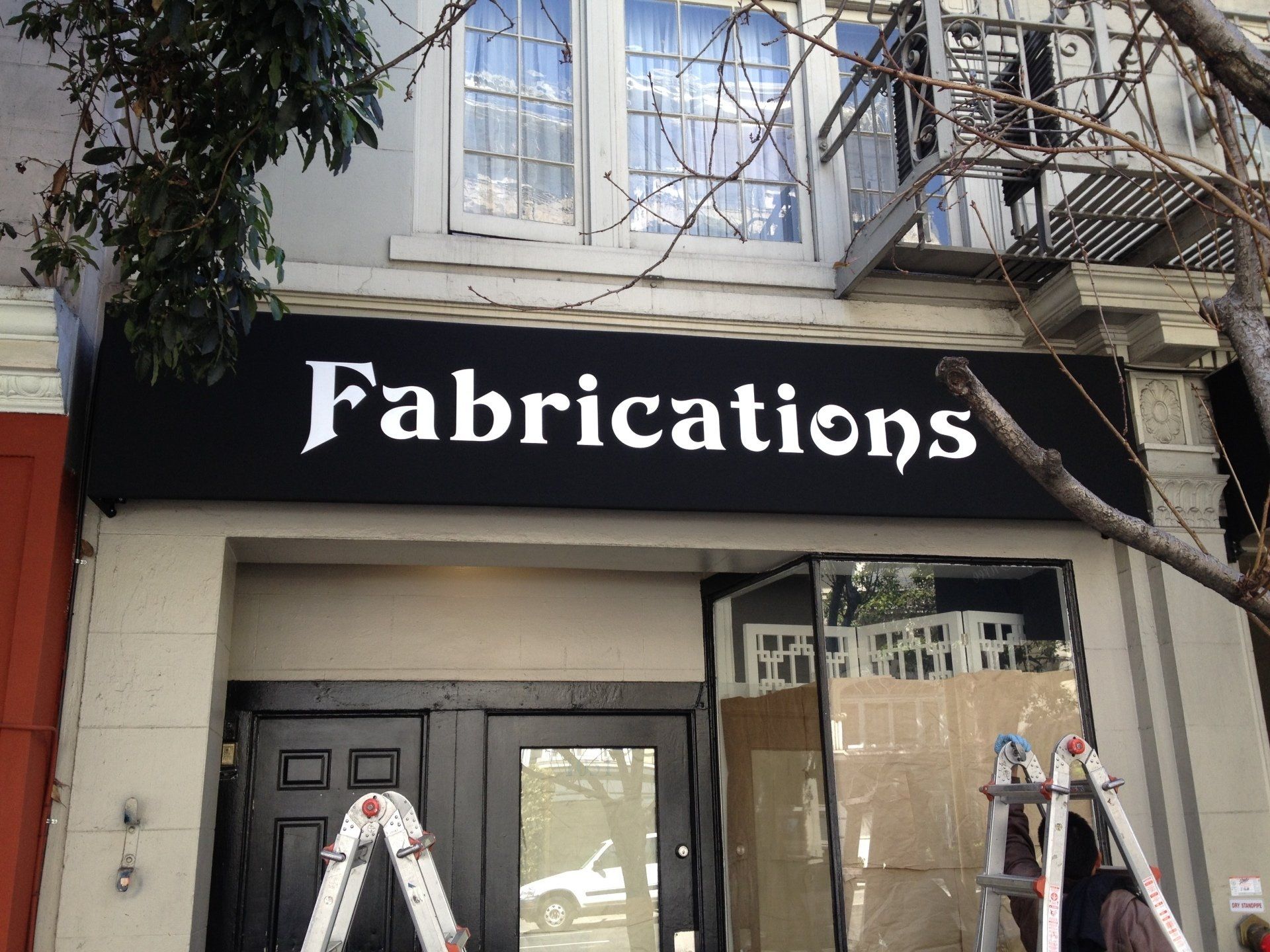 A building with a sign that says fabrications on it