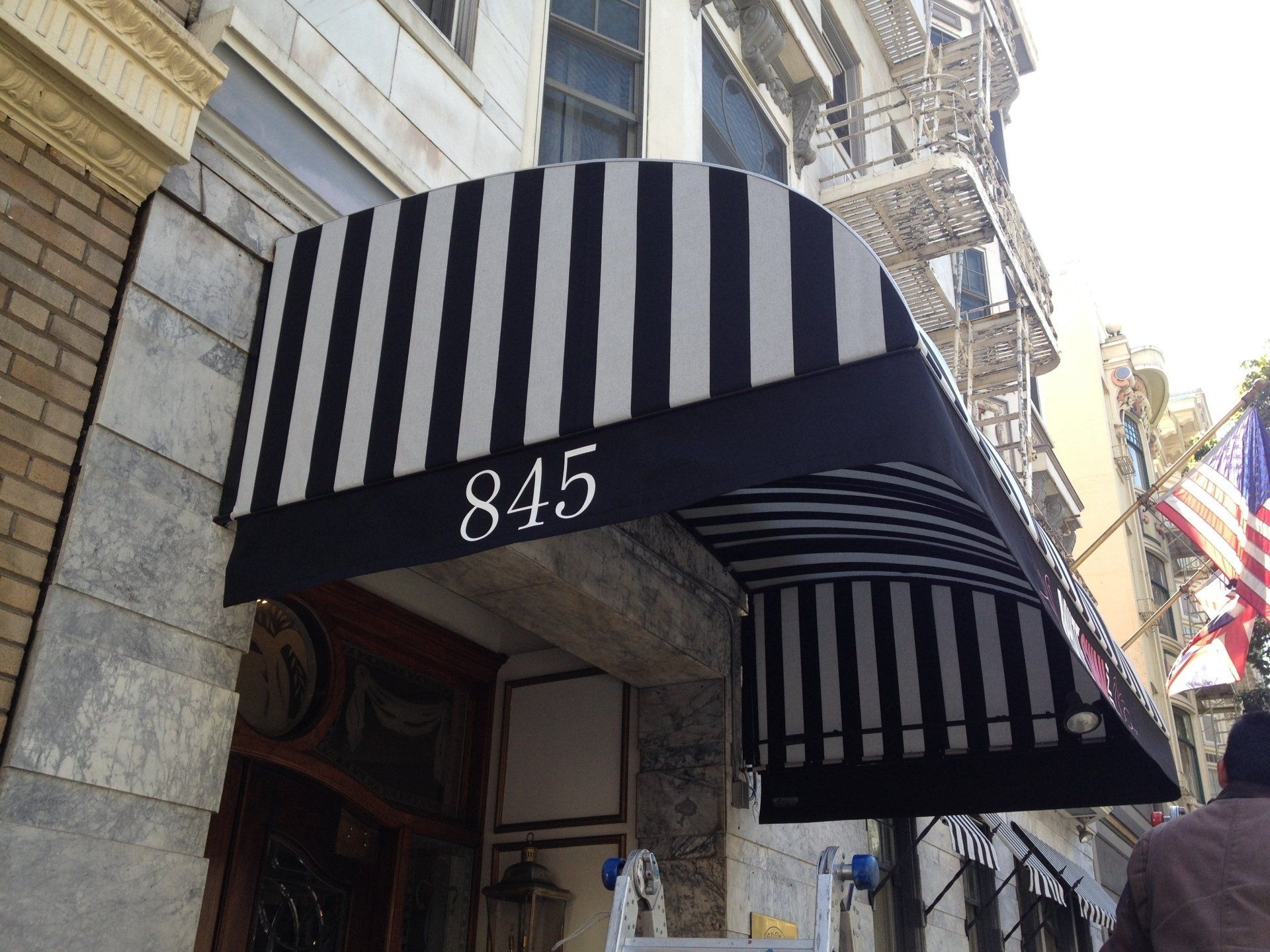 A black and white awning with the number 845 on it