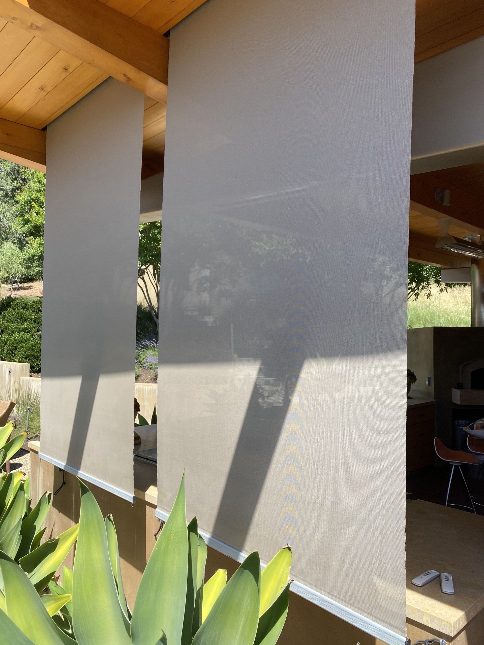 A row of blinds hanging from the ceiling of a building