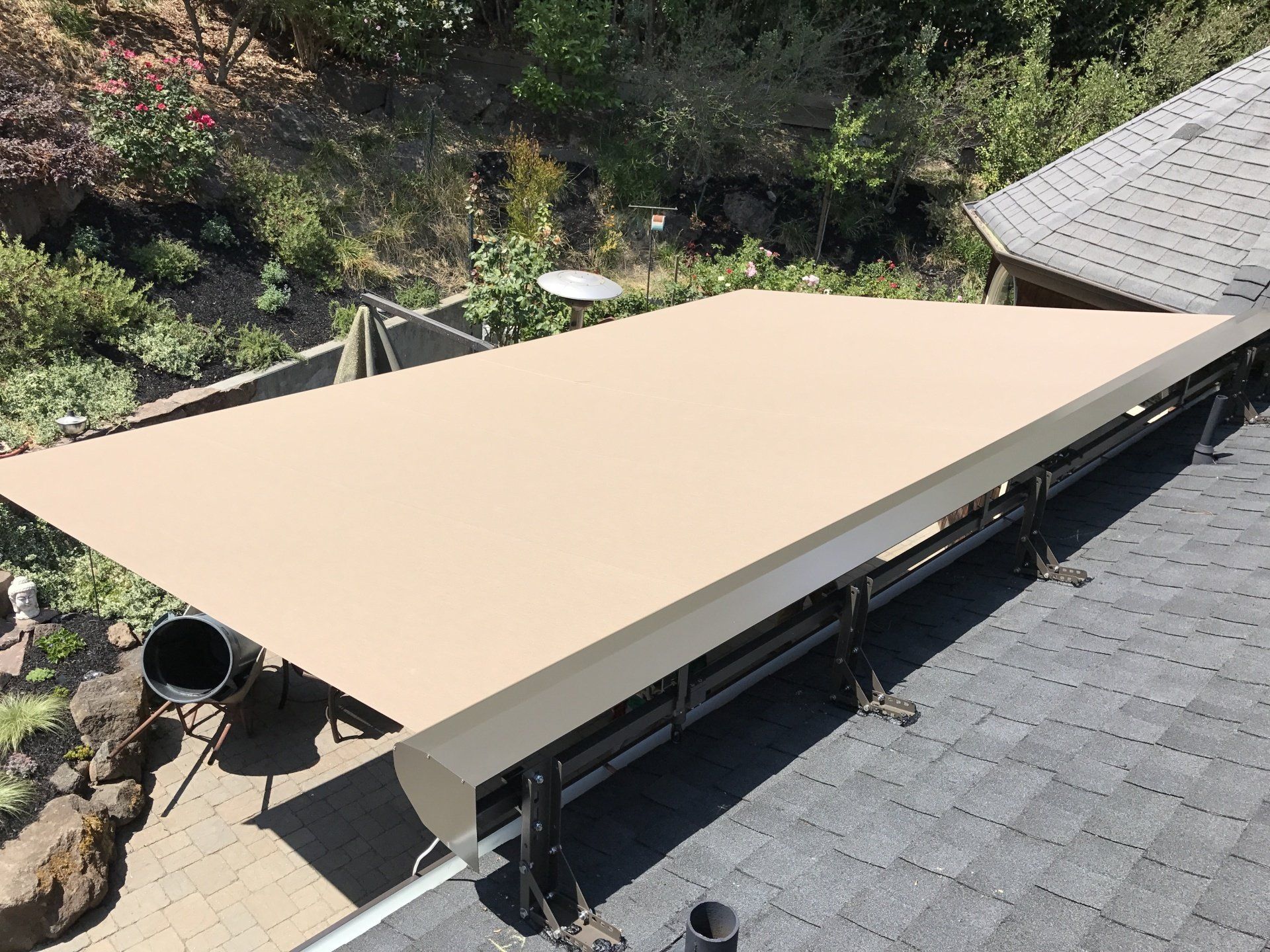 A large umbrella is sitting on top of a roof.