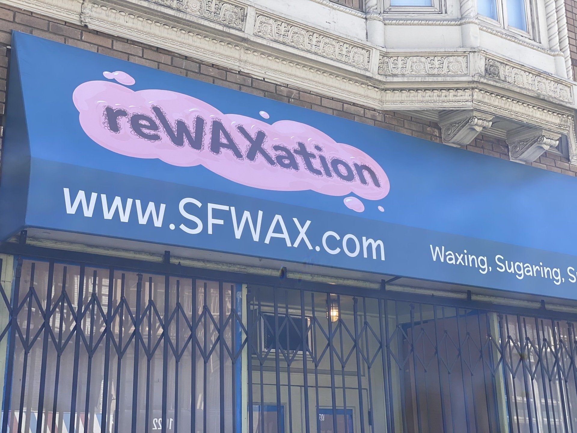 A blue awning with the website www.sfwwax.com on it