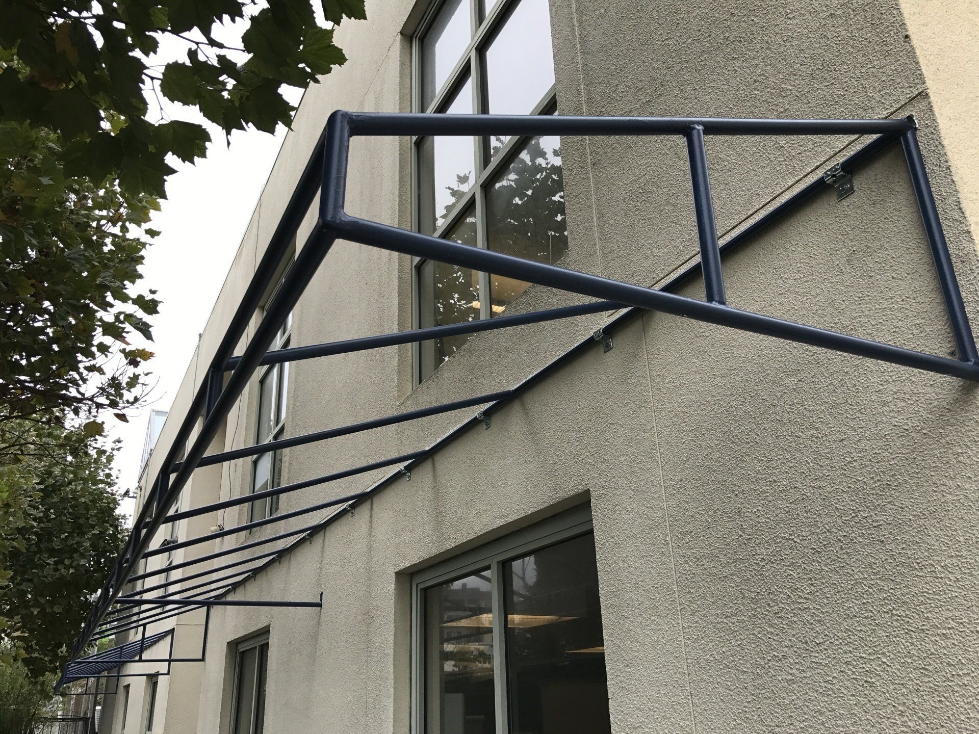 A canopy is attached to the side of a building