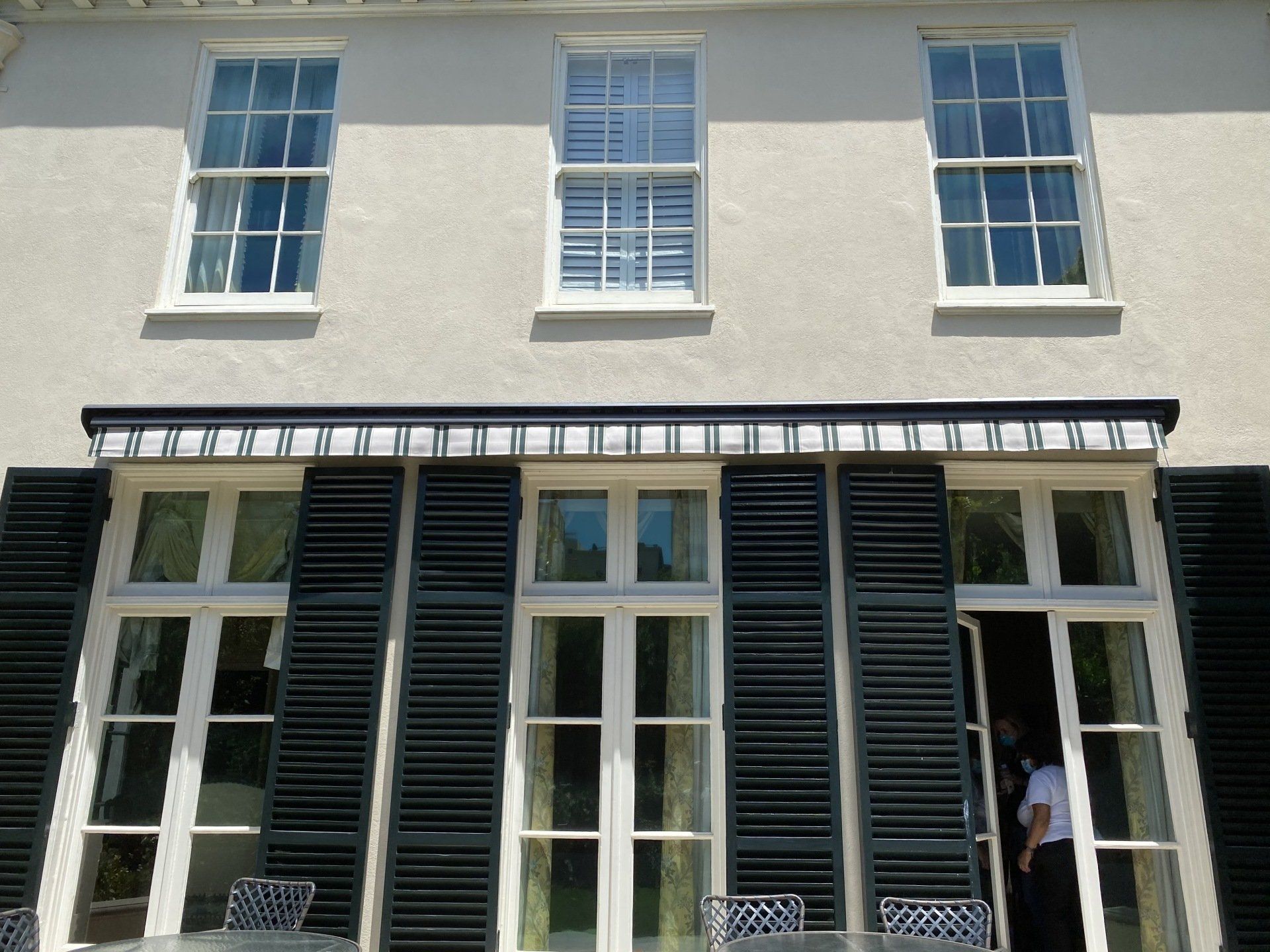 A white house with black shutters on the windows
