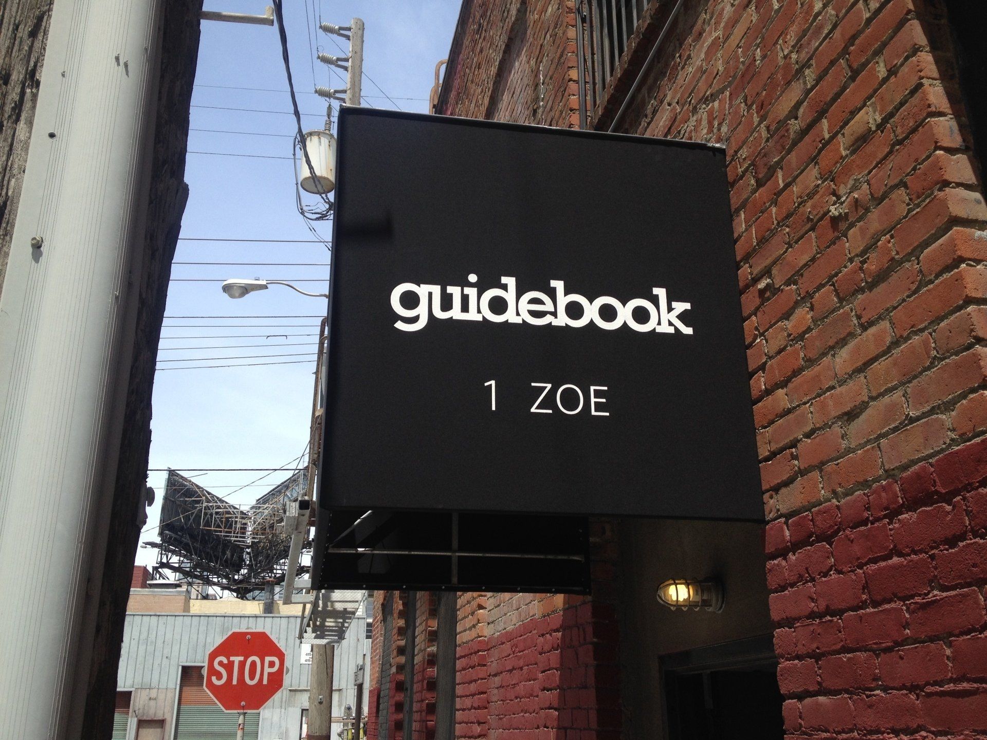 A black sign that says guidebook 1 zoe