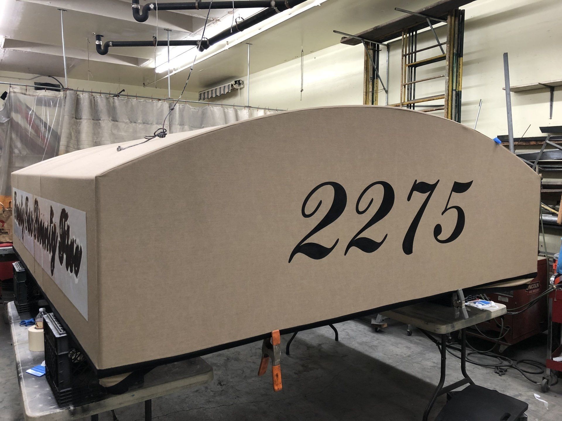 A large piece of wood with the number 2375 on it