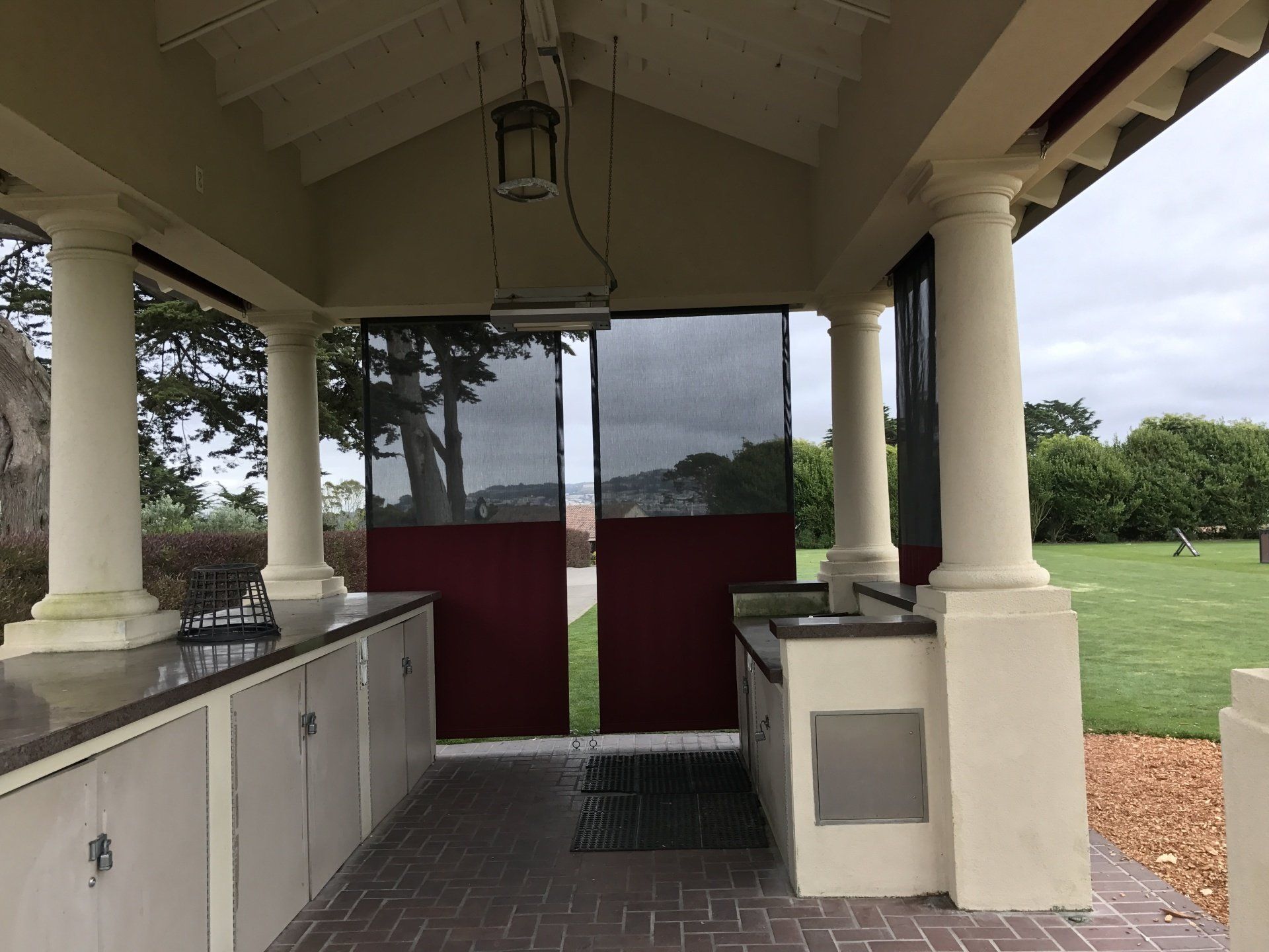 A covered area with a lantern hanging from the ceiling