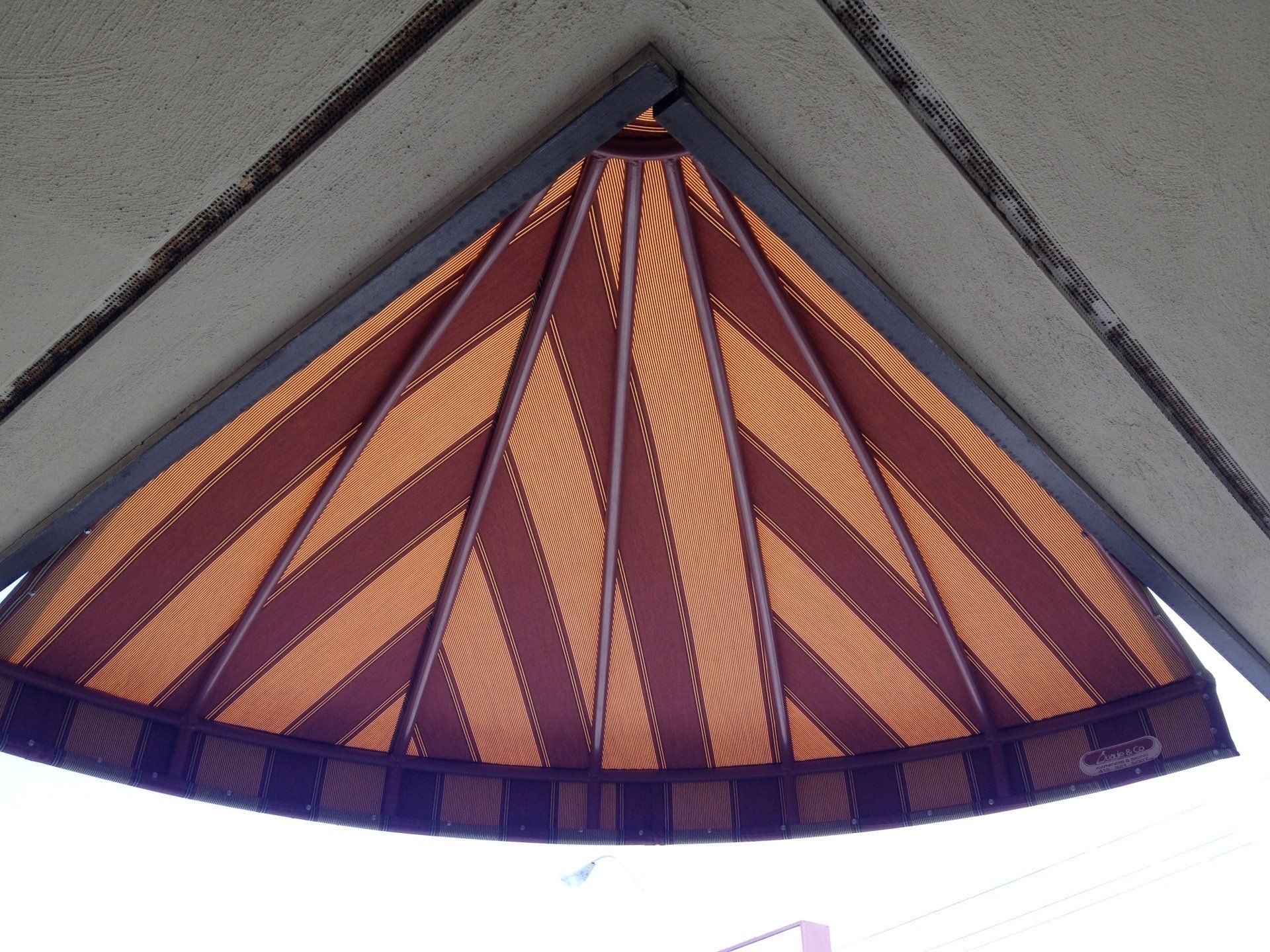 A ceiling with a purple and orange striped pattern