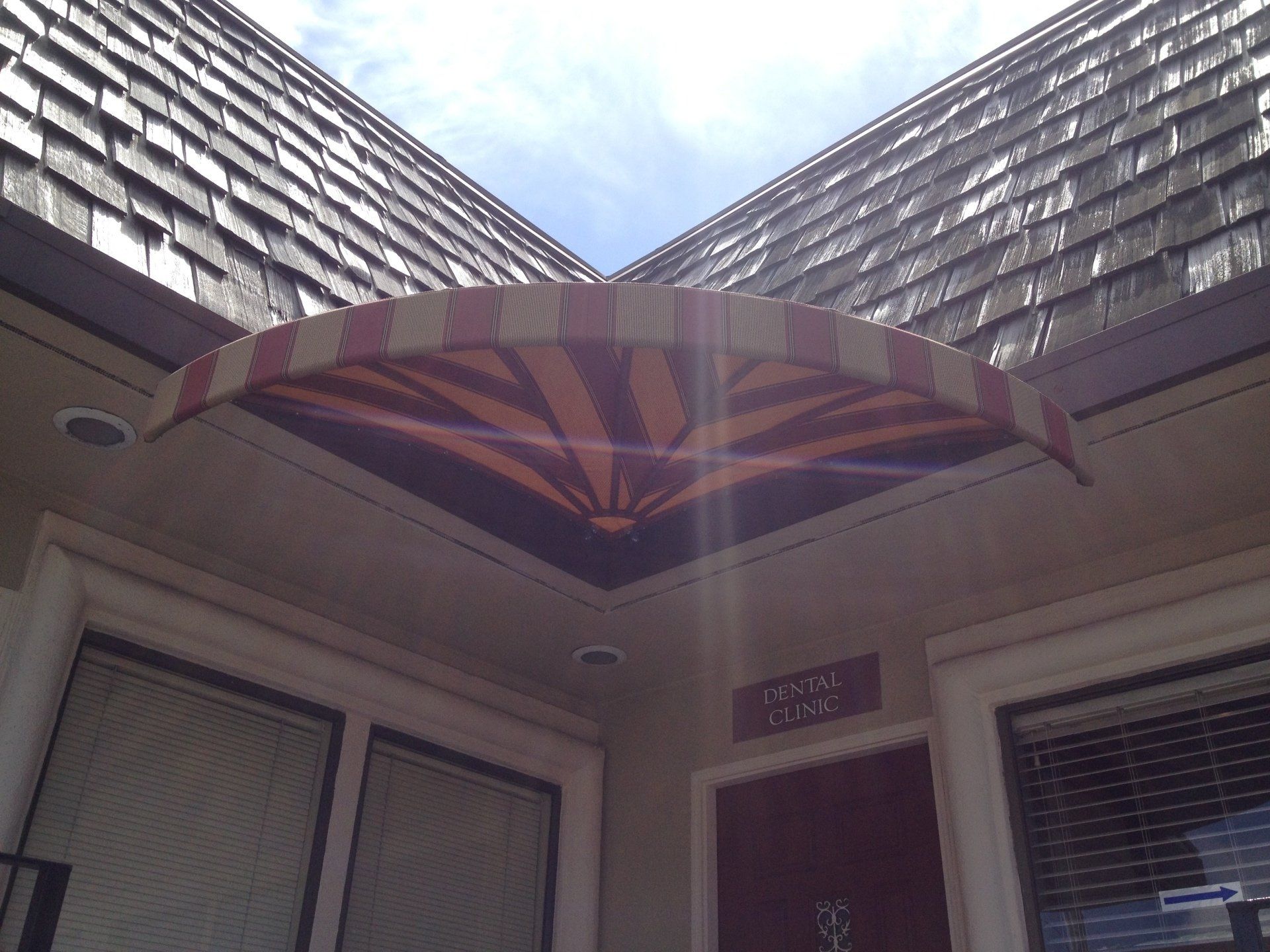 A building with a red and white awning over the door