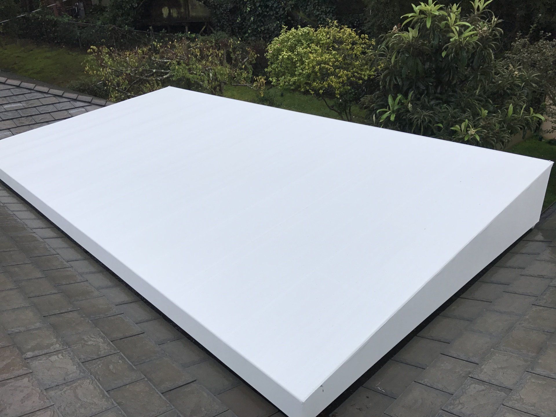 A large white piece of styrofoam is sitting on a roof