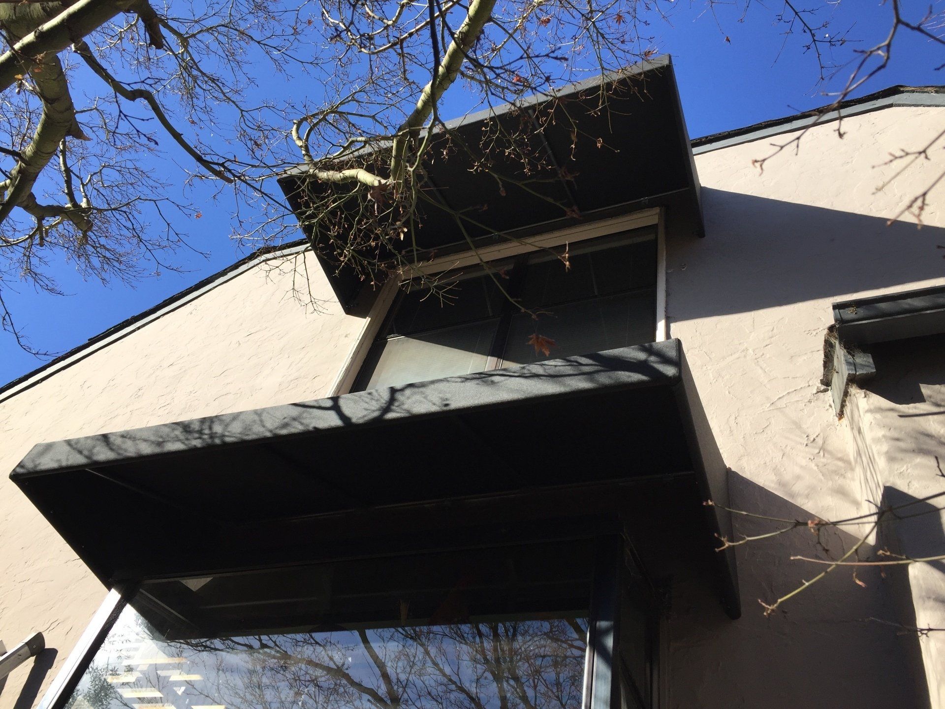 A building with a black awning on the side of it