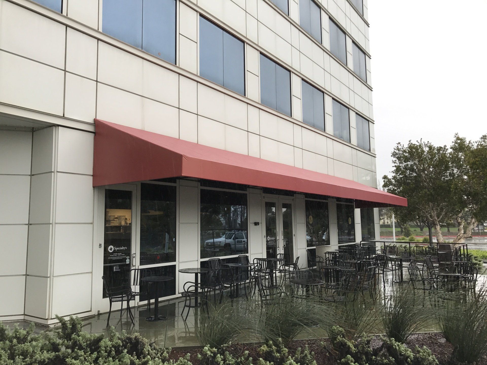 A building with a red awning on the side of it