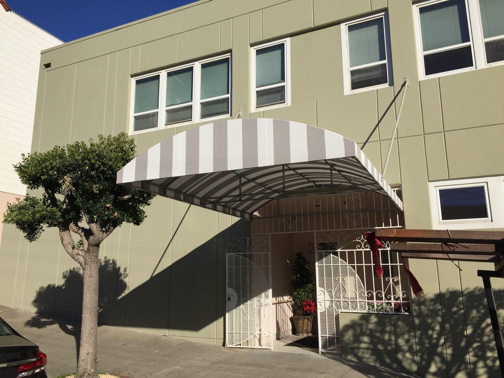 A building with a striped awning over the entrance